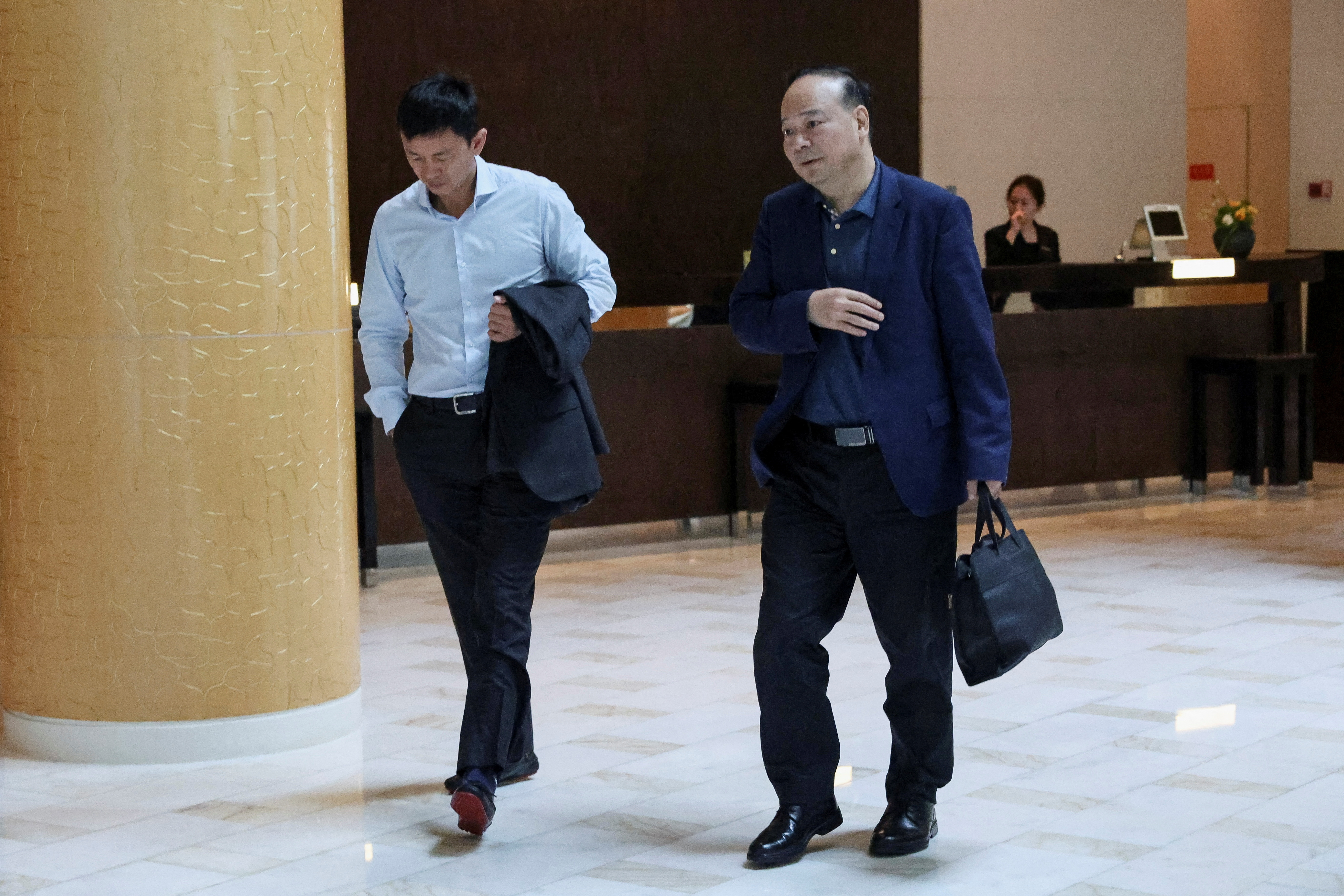 Robin Zeng, chairman of Chinese battery giant CATL, walks at a hotel where Tesla CEO Elon Musk is staying, in Beijing