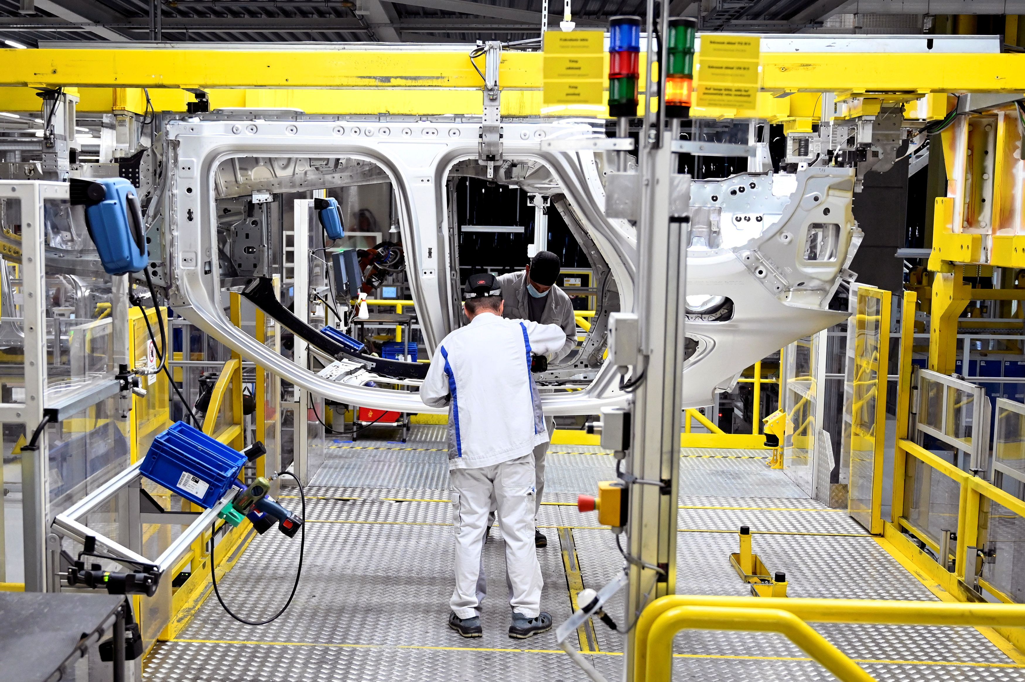 FILE PHOTO: Employees work on an assembly line as the Volkswagen construction plant reopens after closing down last month due to the coronavirus disease (COVID-19) outbreak in Bratislava