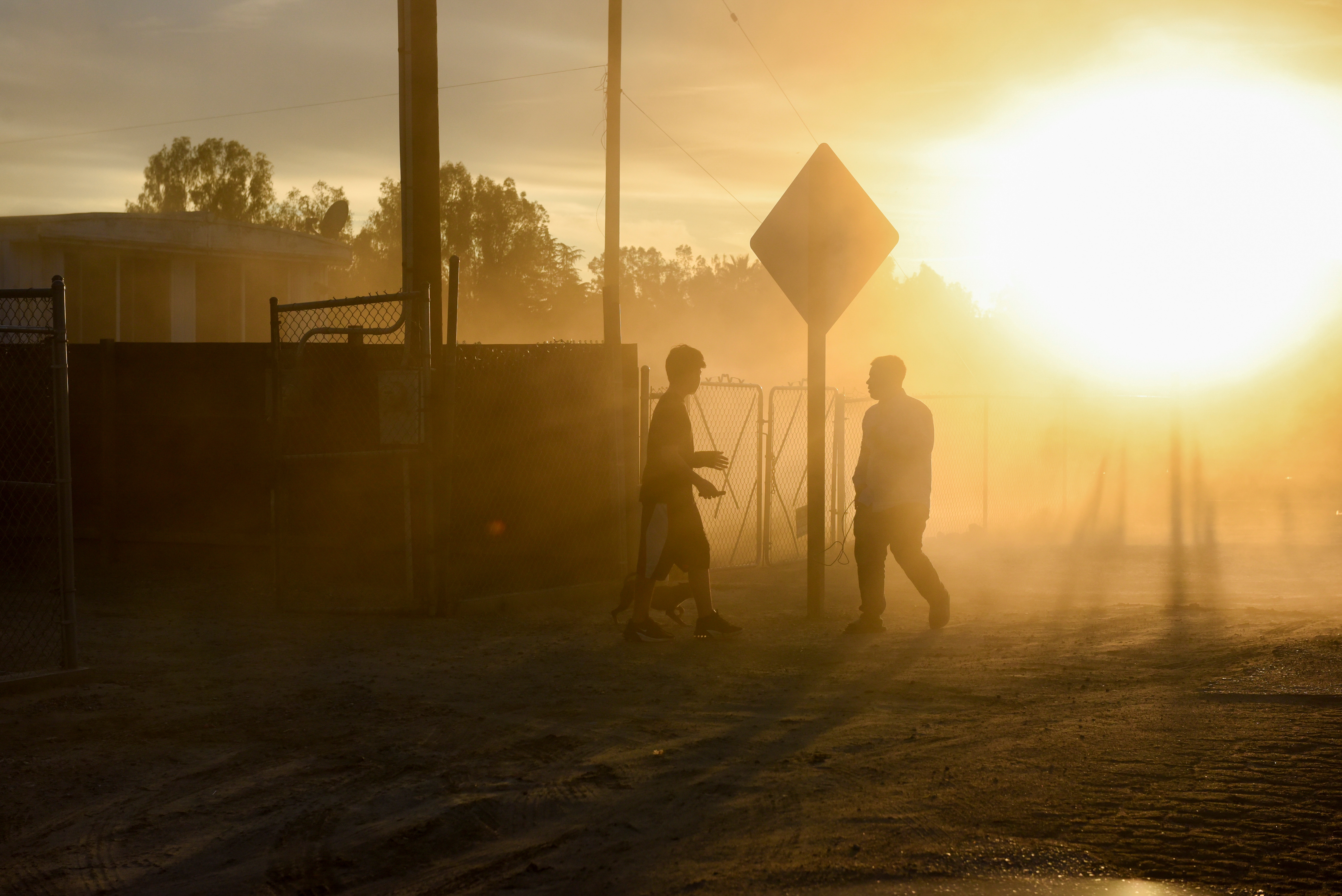 Two young people greet each other at sunset in Teviston, California, U.S., October 20, 2021.  REUTERS/Stephanie Keith