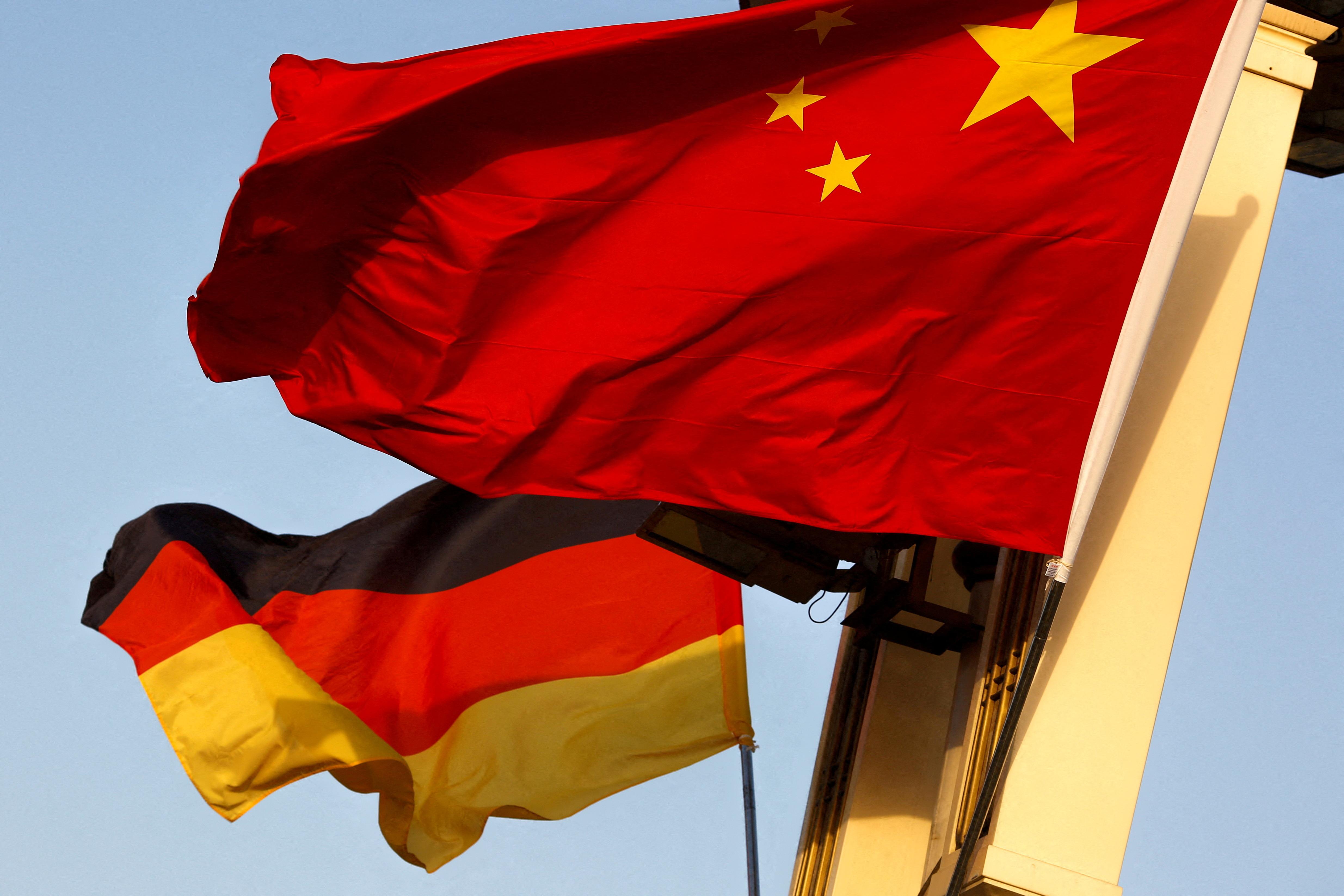German and Chinese national flags fly in Tiananmen Square in Beijing