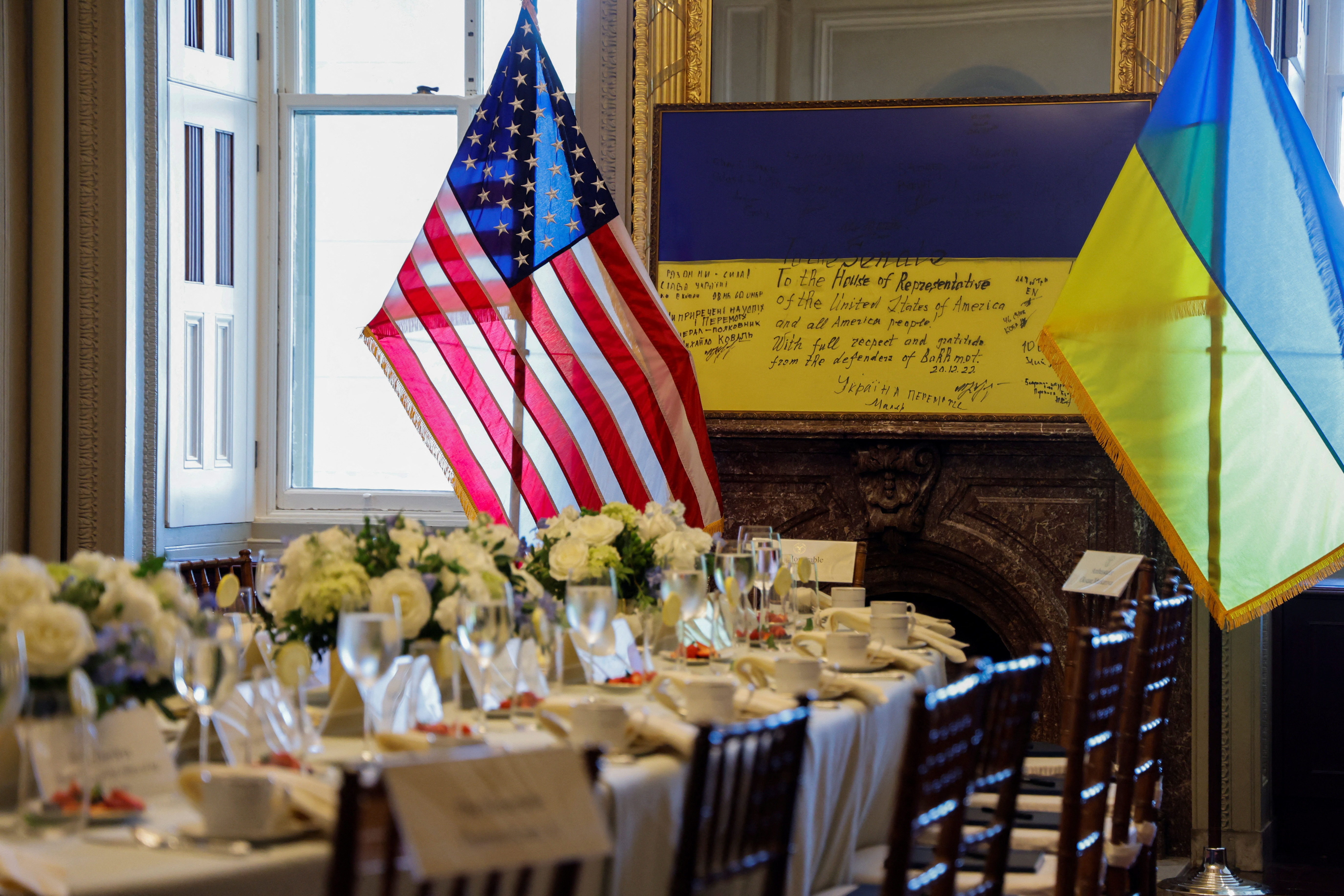 A framed flag signed by front-line Ukrainian fighters in Bakhmut and presented to the U.S. Congress in 2022, sits at one end of the table the U.S. Capitol, in Washington