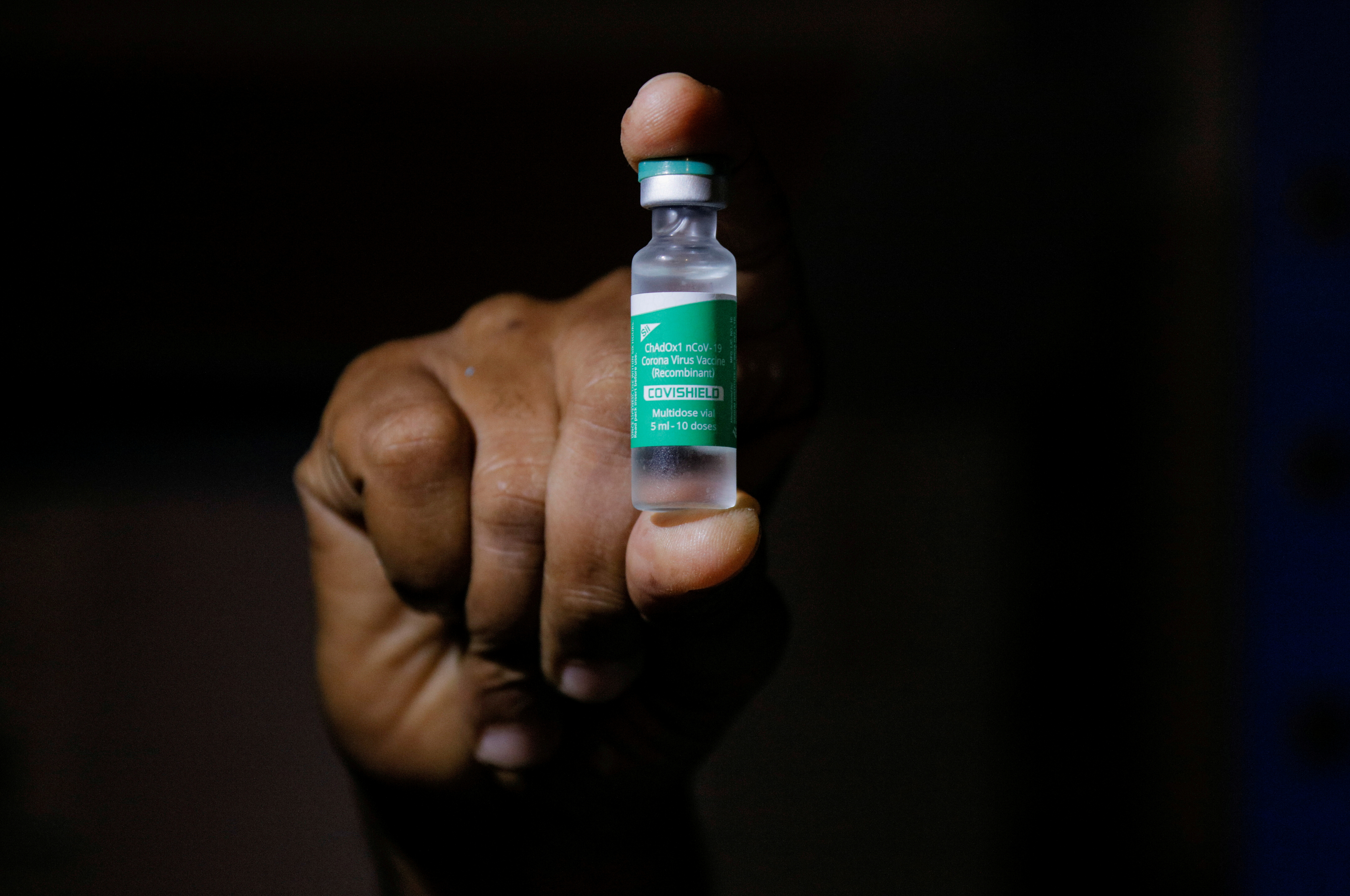 A man displays a vial AstraZeneca's COVISHIELD vaccine as the country receives its first batch of coronavirus disease (COVID-19) vaccines under COVAX scheme, in Accra
