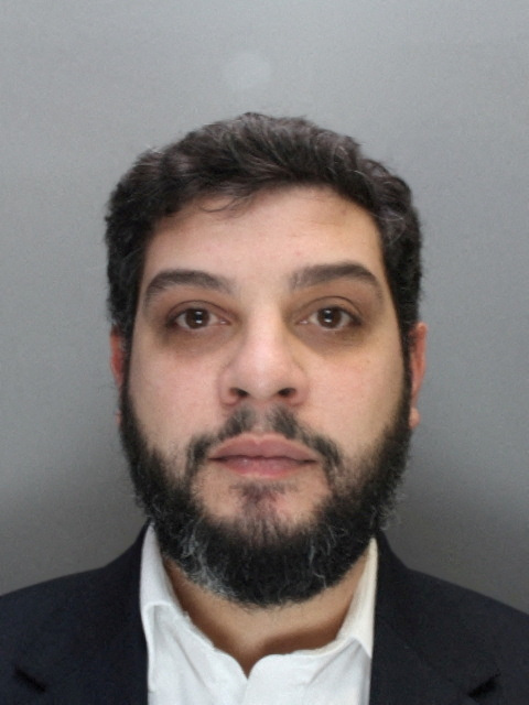 Anthony Constantinou, British foreign exchange company boss, is shown in a police booking mugshot