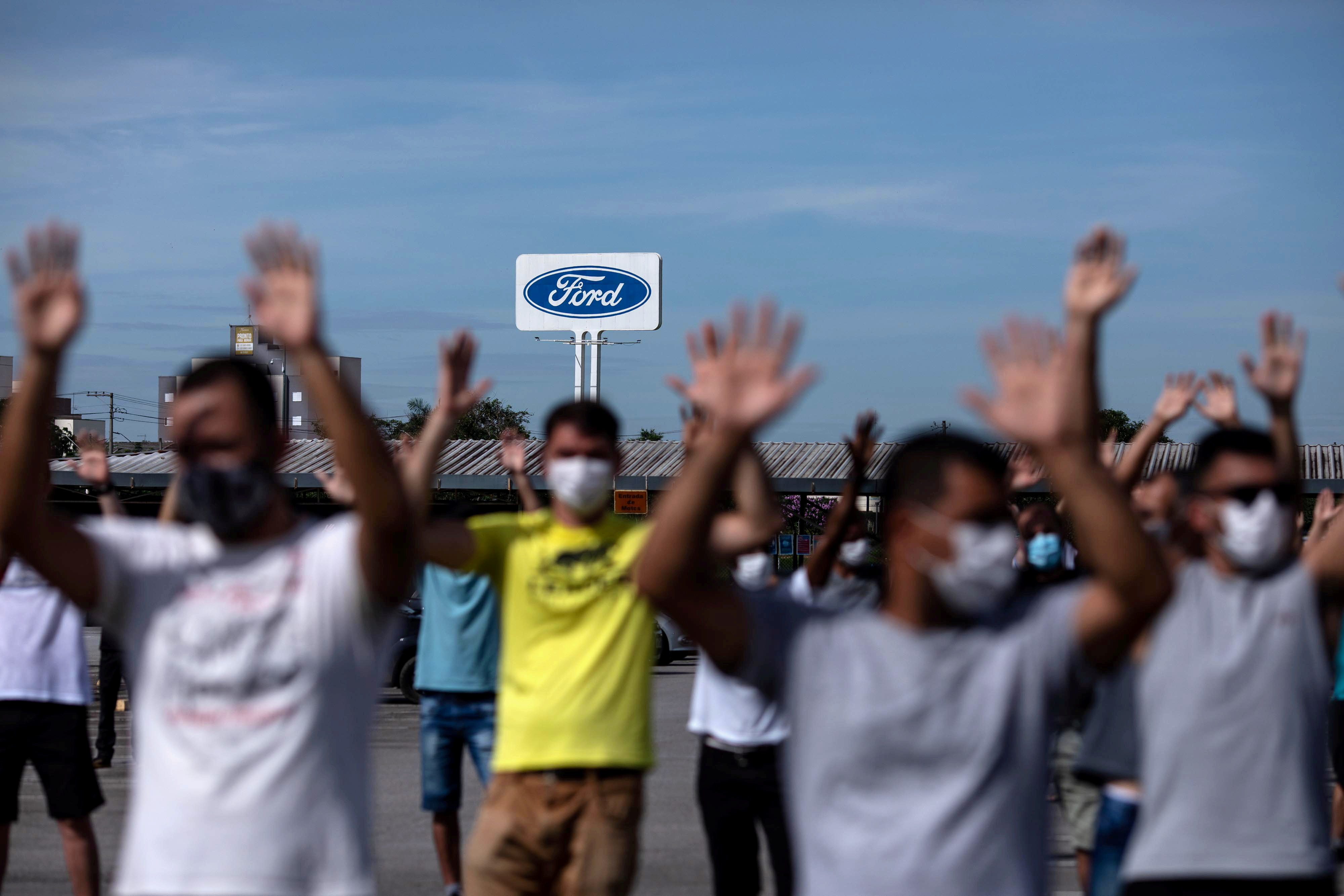 Workers protest outside a Ford Motor Co plant, after the company announced it will close its three plants in the country, in Taubate, Brazil, January 18, 2021. REUTERS/Roosevelt Cassio