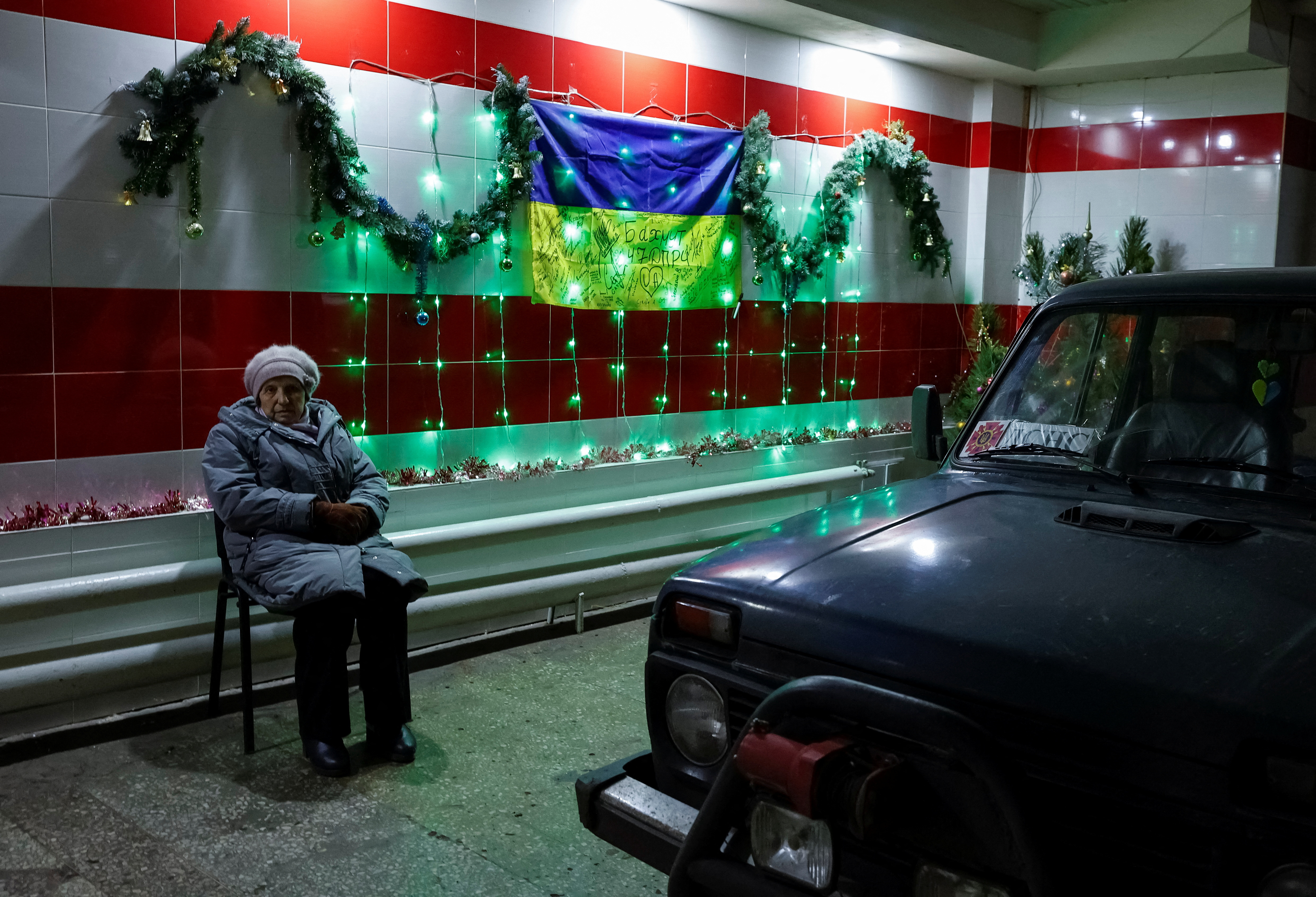 A woman warms up inside a State Emergency Service station in the town of Bakhmut