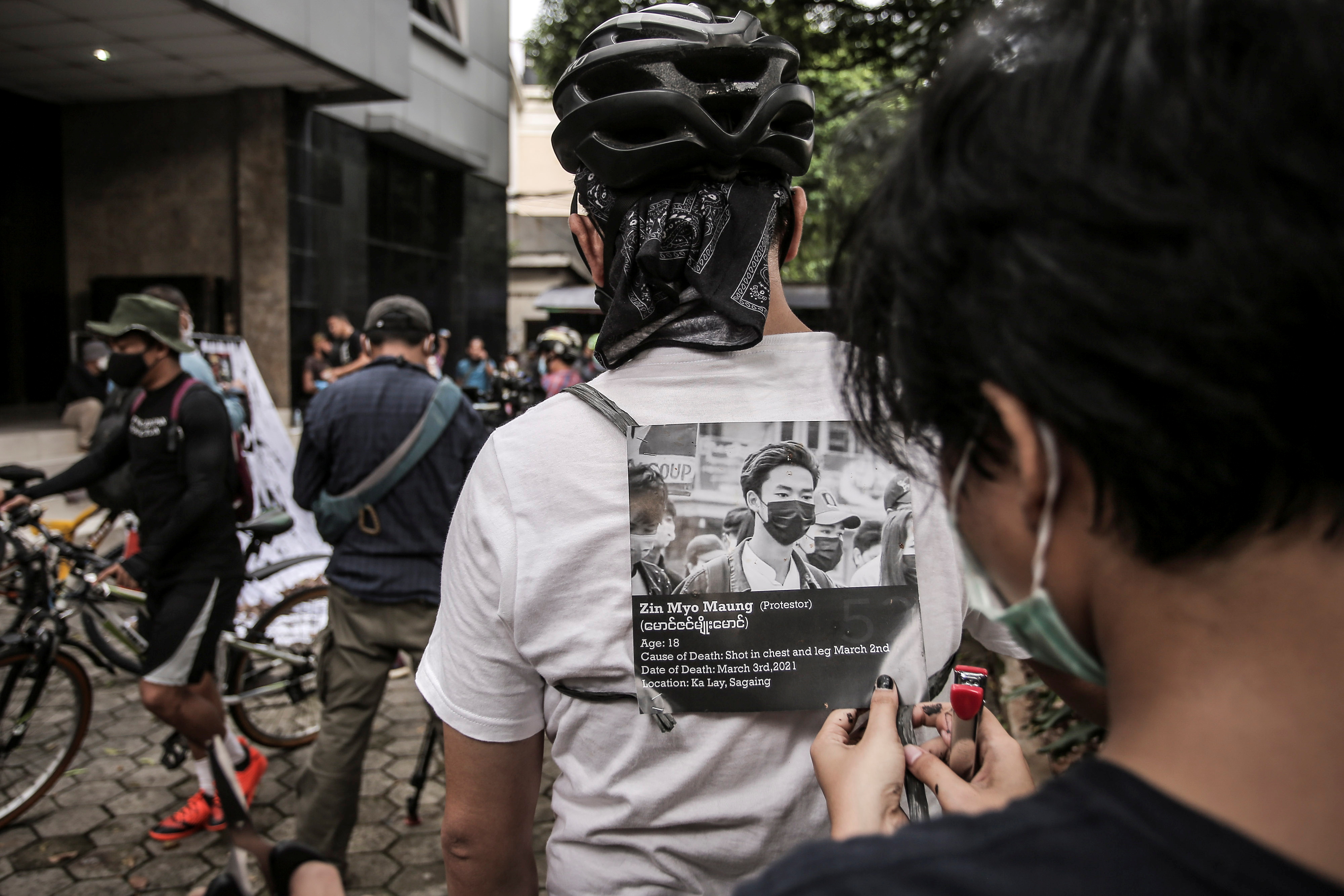 Activists prepare to take part in a protest called 'Bike for Democracy', against the military coup in Myanmar