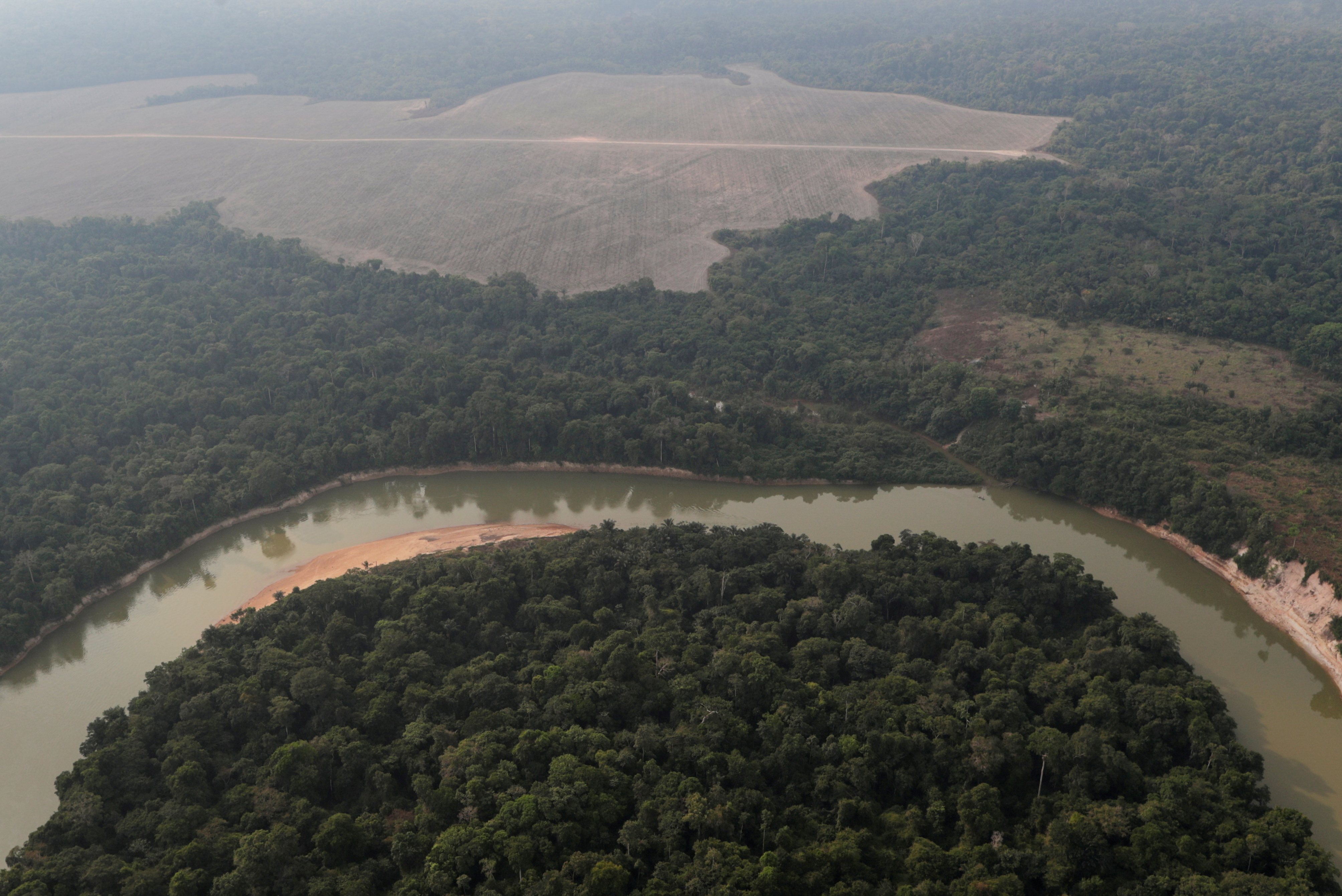 An aerial view shows a river and a deforested plot of the Amazon near Porto Velho
