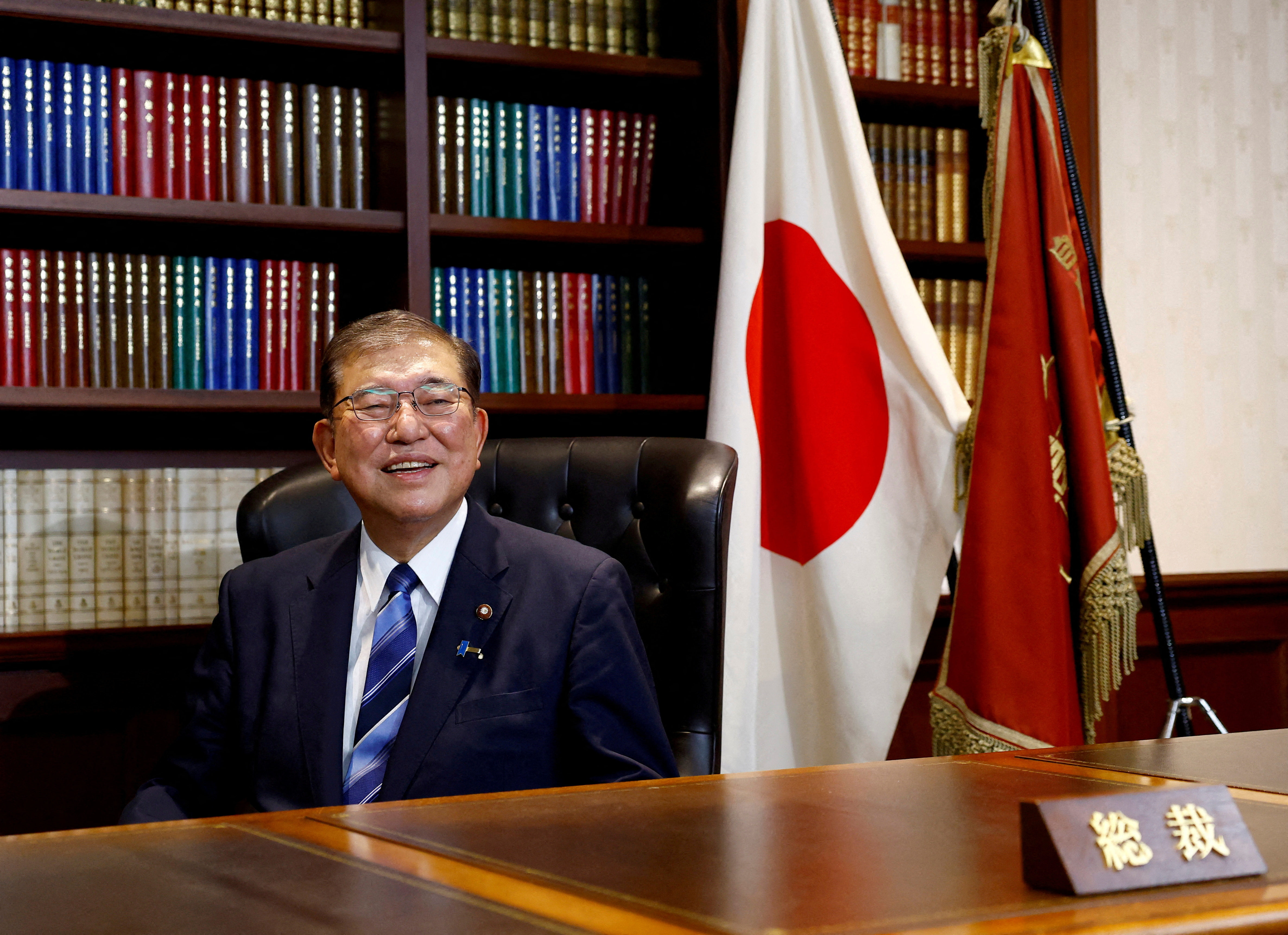 Shigeru Ishiba, the newly elected leader of Japan's ruling party, the Liberal Democratic Party (LDP) poses in the party leader's office after the LDP leadership election, in Tokyo