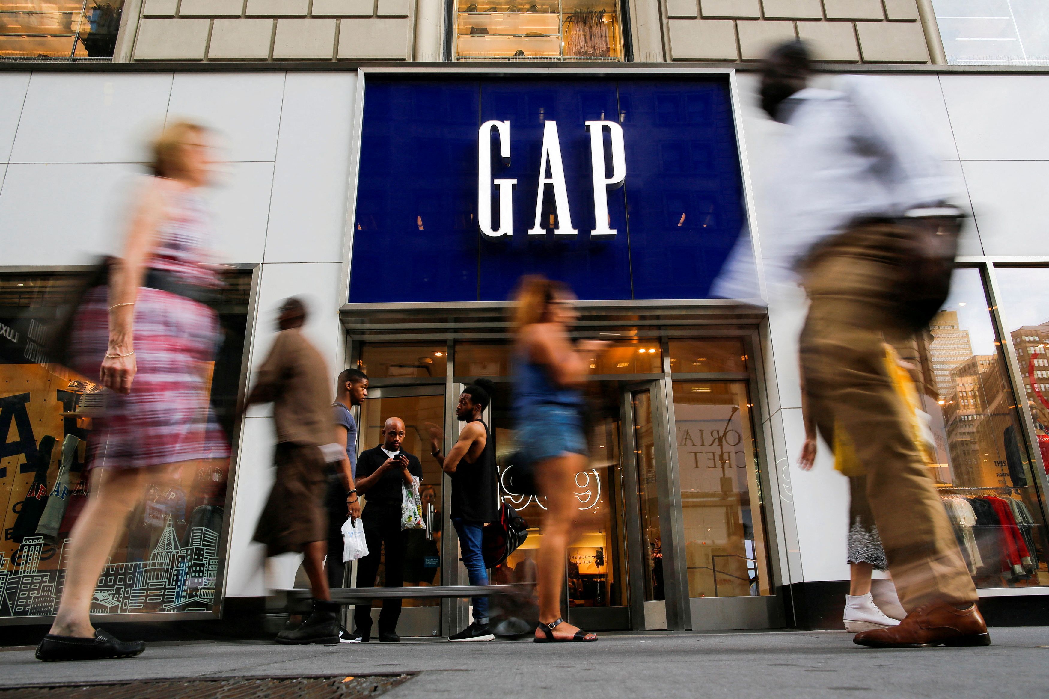 People pass by the GAP clothing retail store in Manhattan, New York
