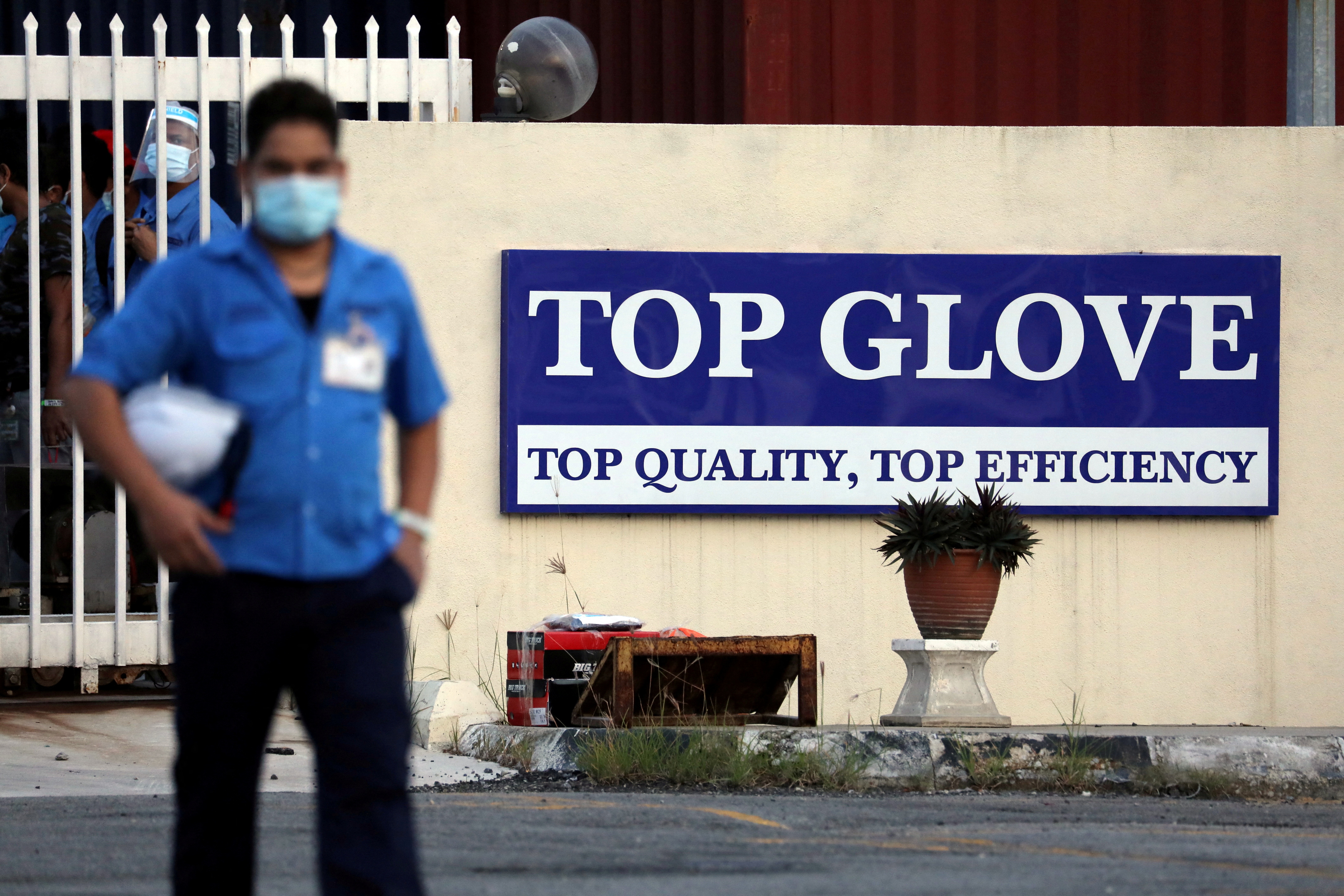 A worker leaves a Top Glove factory after his shift in Klang