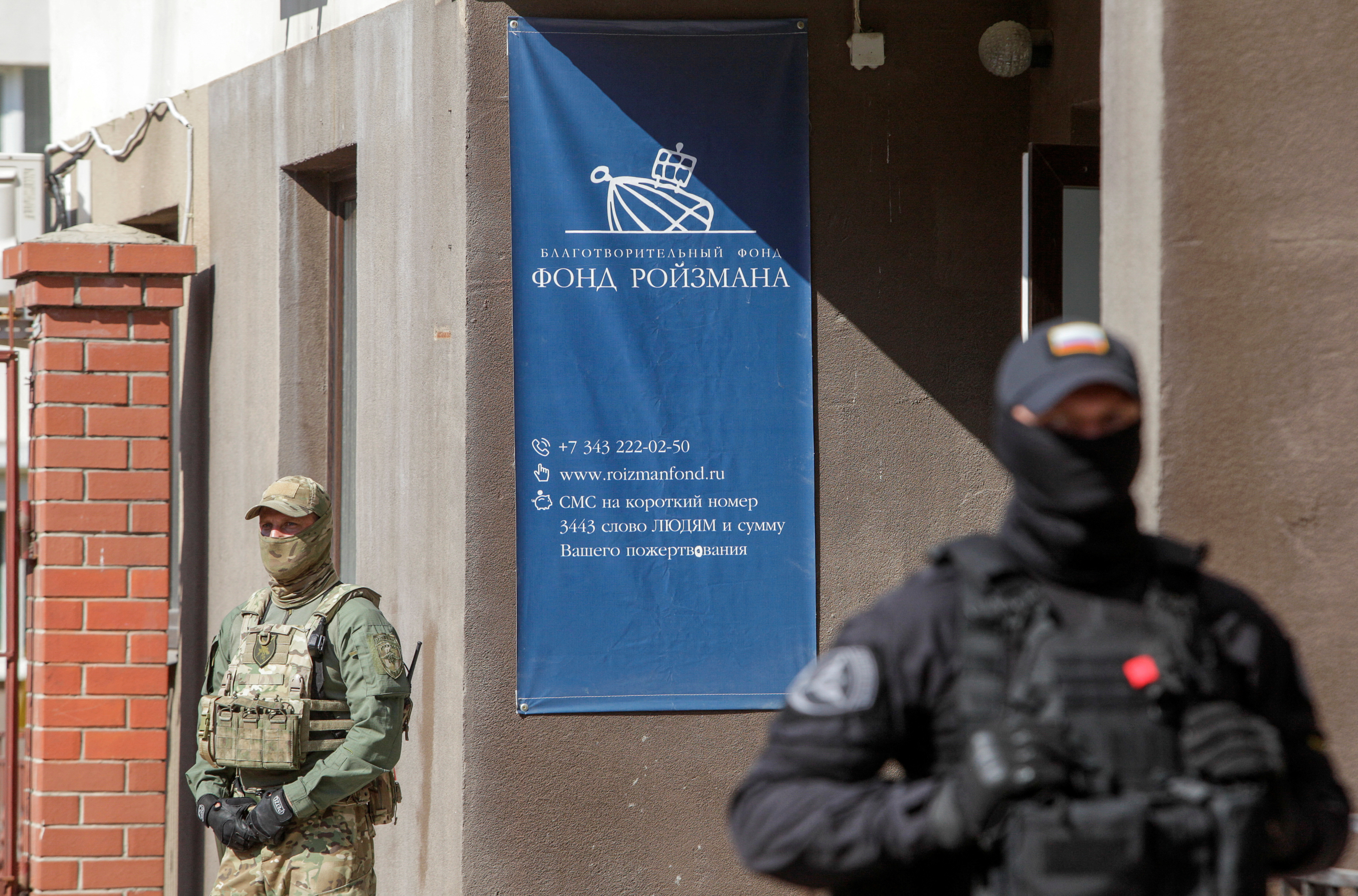 Officers stand guard outside the office of Yevgeny Roizman's charity fund in Yekaterinburg