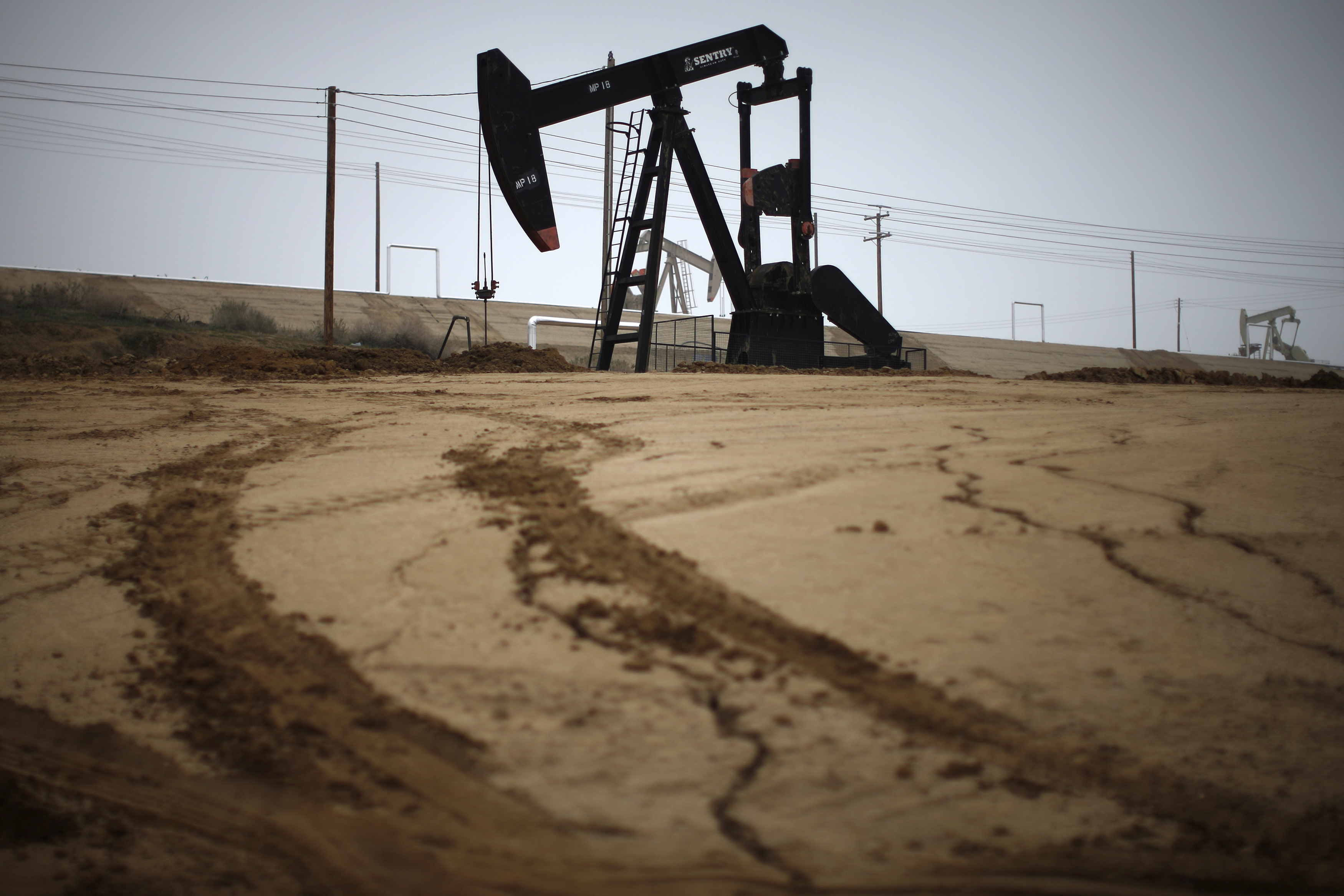 Pump jack is seen on an oil field near Bakersfield on a foggy day
