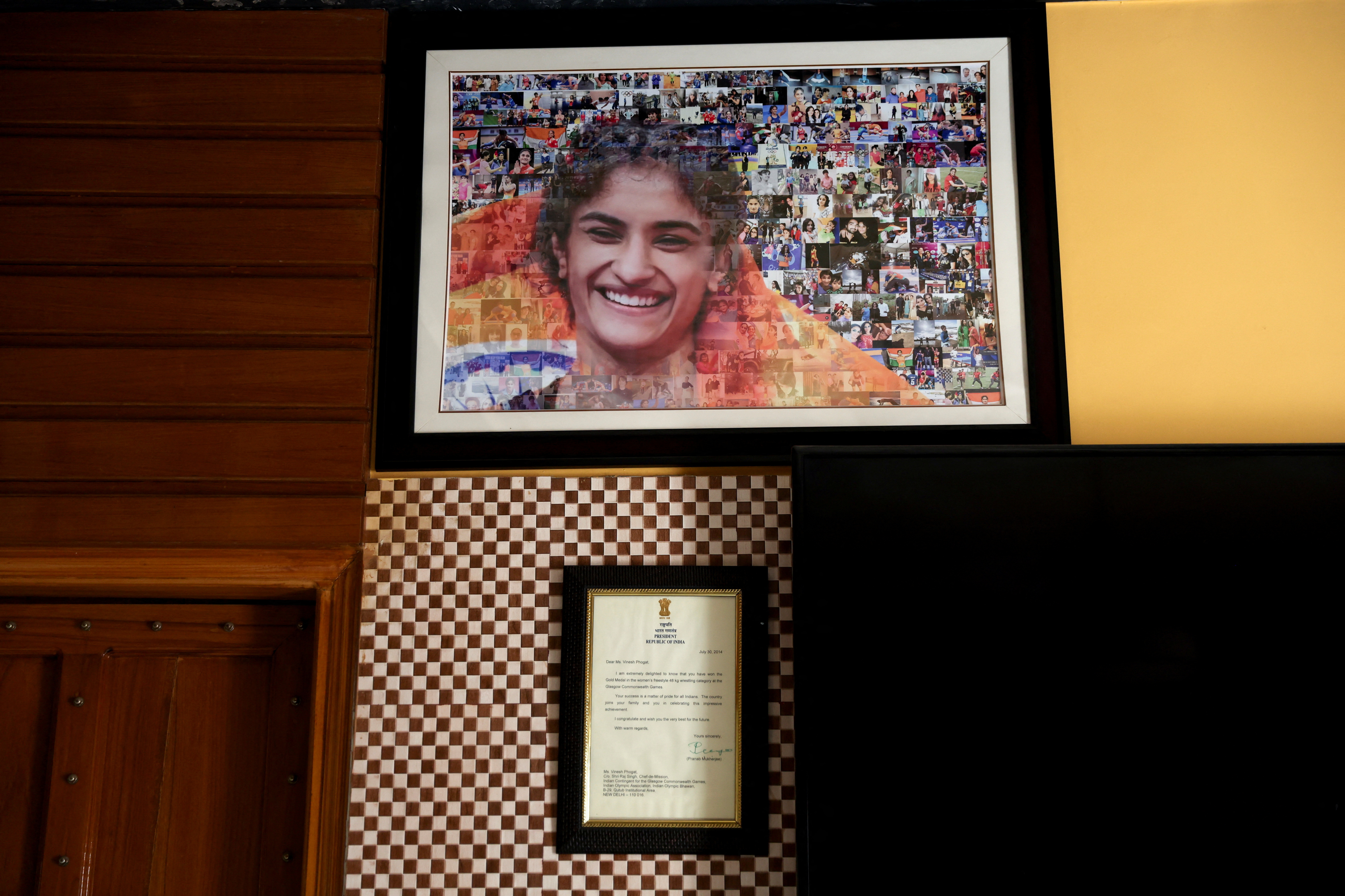 A picture of of Indian wrestler Vinesh Phogat hangs on a wall at her residence in Sonipat