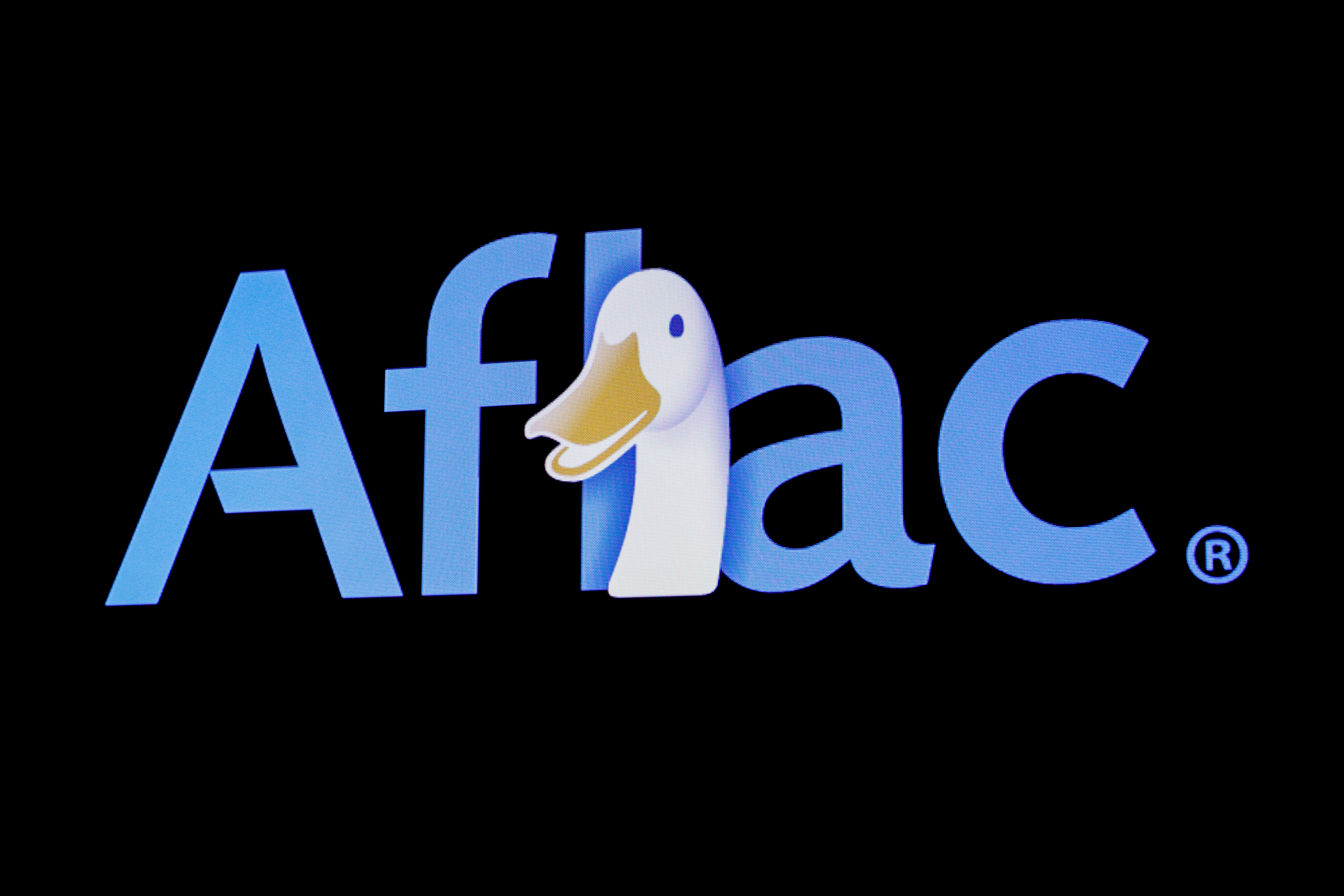 The company logo for Aflac is displayed on a screen on the floor at the NYSE in New York