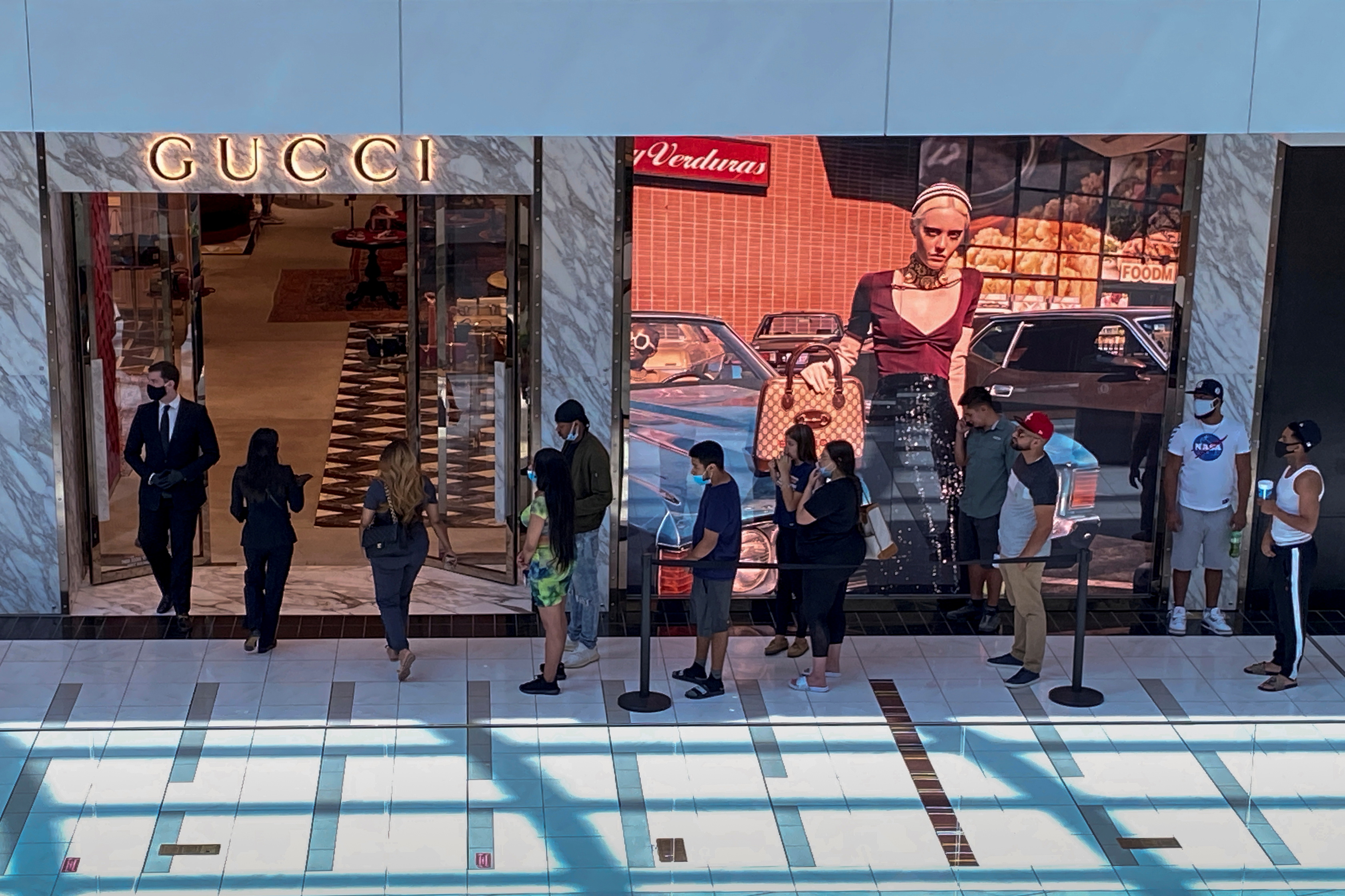 Customers line up to enter a Gucci fashion store at the The Galleria shopping mall after the mall opened during the coronavirus disease (COVID -19) outbreak in Houston