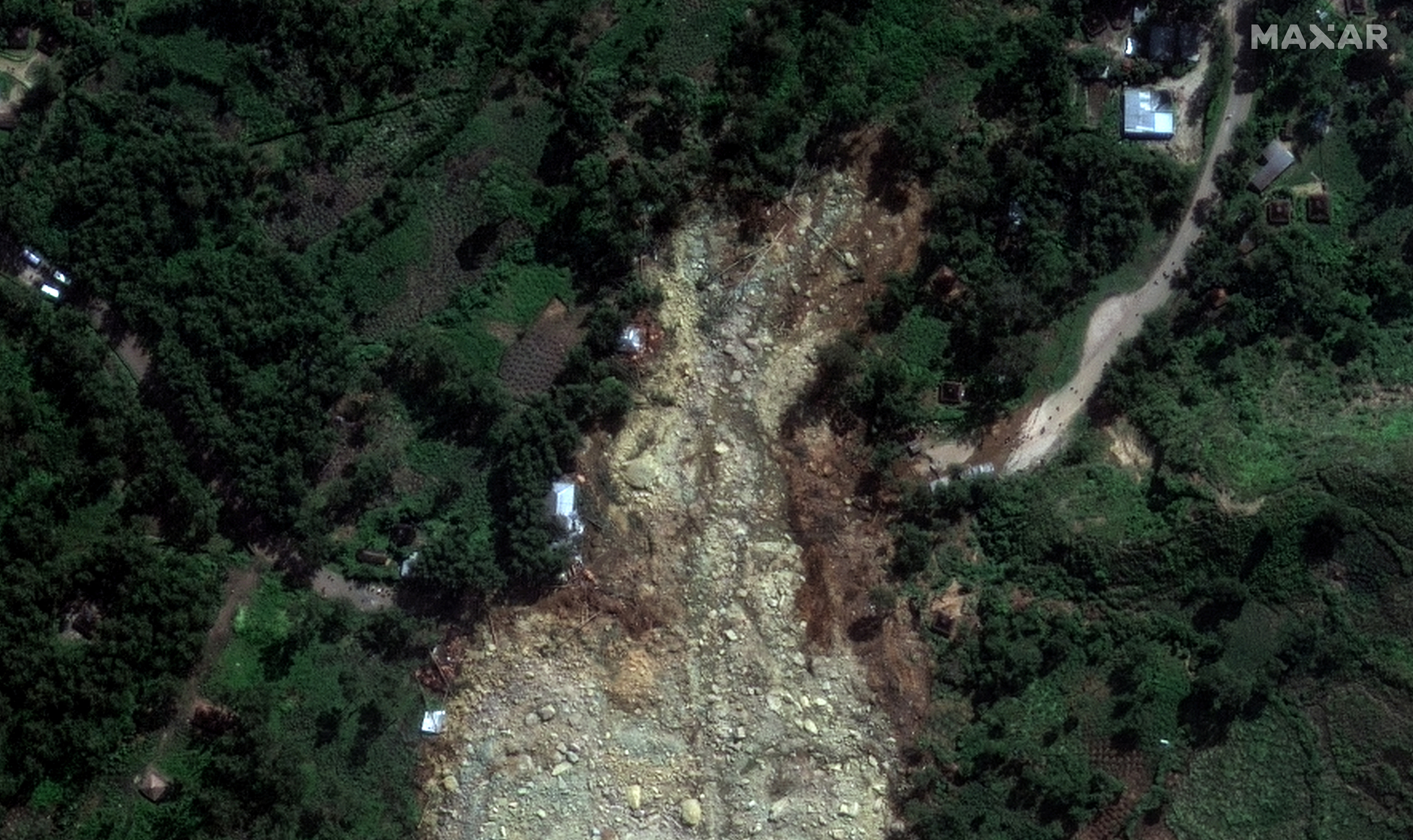 A satellite image shows buried homes after the landslide in Yambali village
