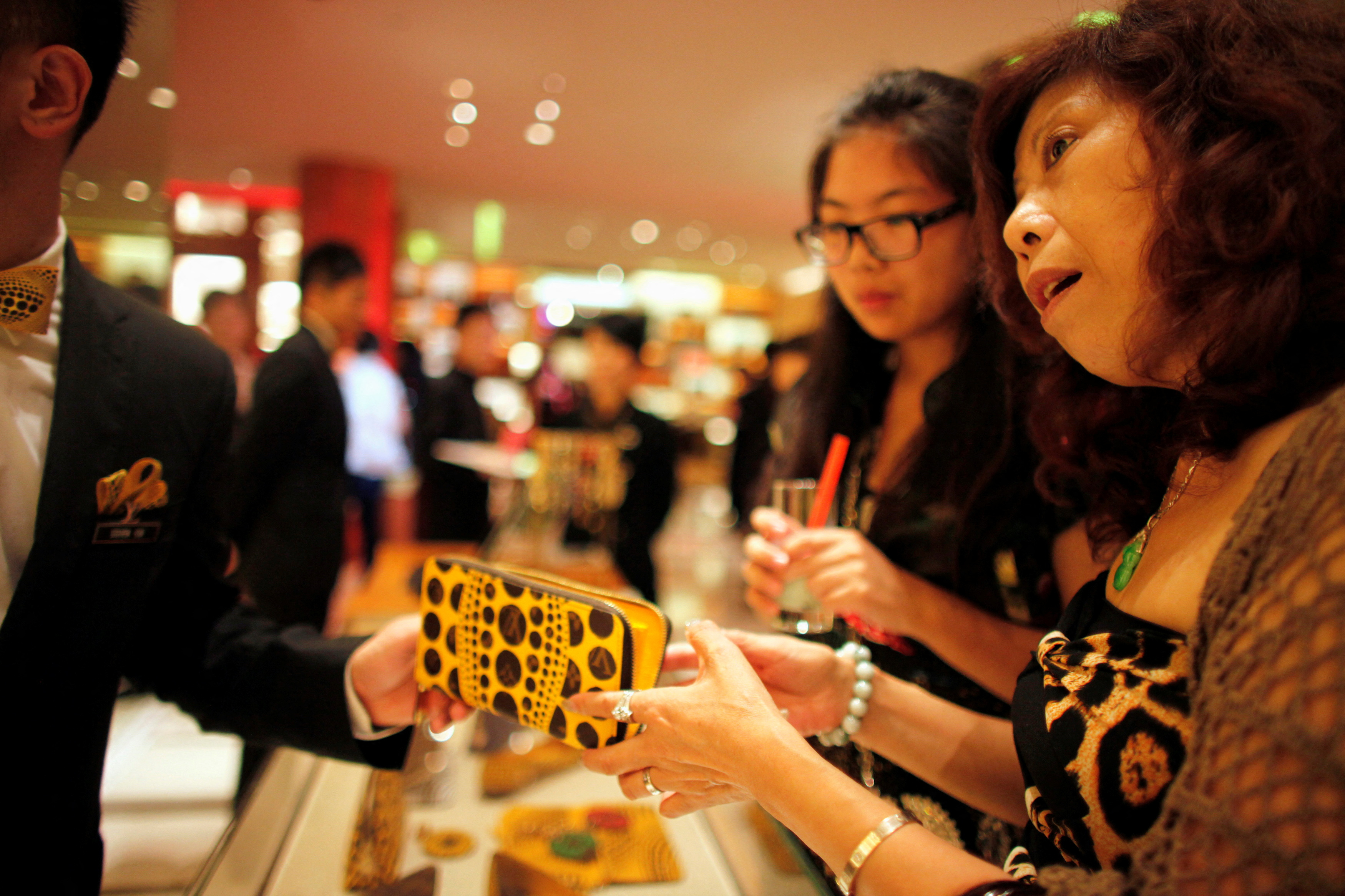 A woman shops in Louis Vuitton store during Vogue's 4th Fashion's Night Out in downtown Shanghai