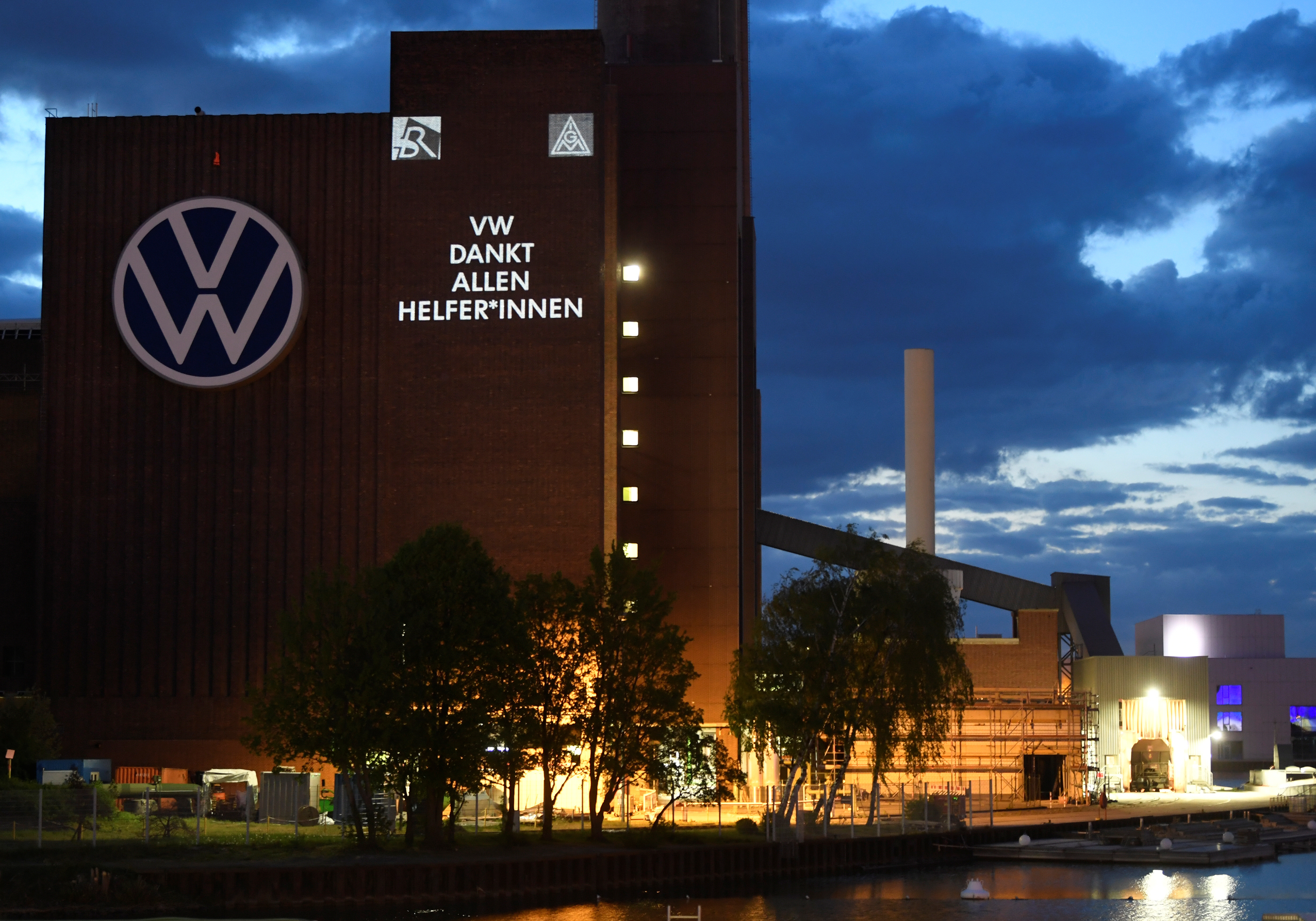 A slogan reading "VW thanks all Helpers" is displayed on a building at Volkswagen's headquarters to celebrate the plant's re-opening during the spread of the coronavirus disease (COVID-19) in Wolfsburg