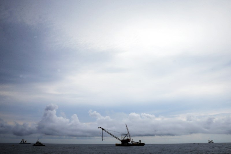 Construction barge and crane float next to the first jacket installed to support a turbine for a wind farm in the waters of the Atlantic Ocean off Block Island