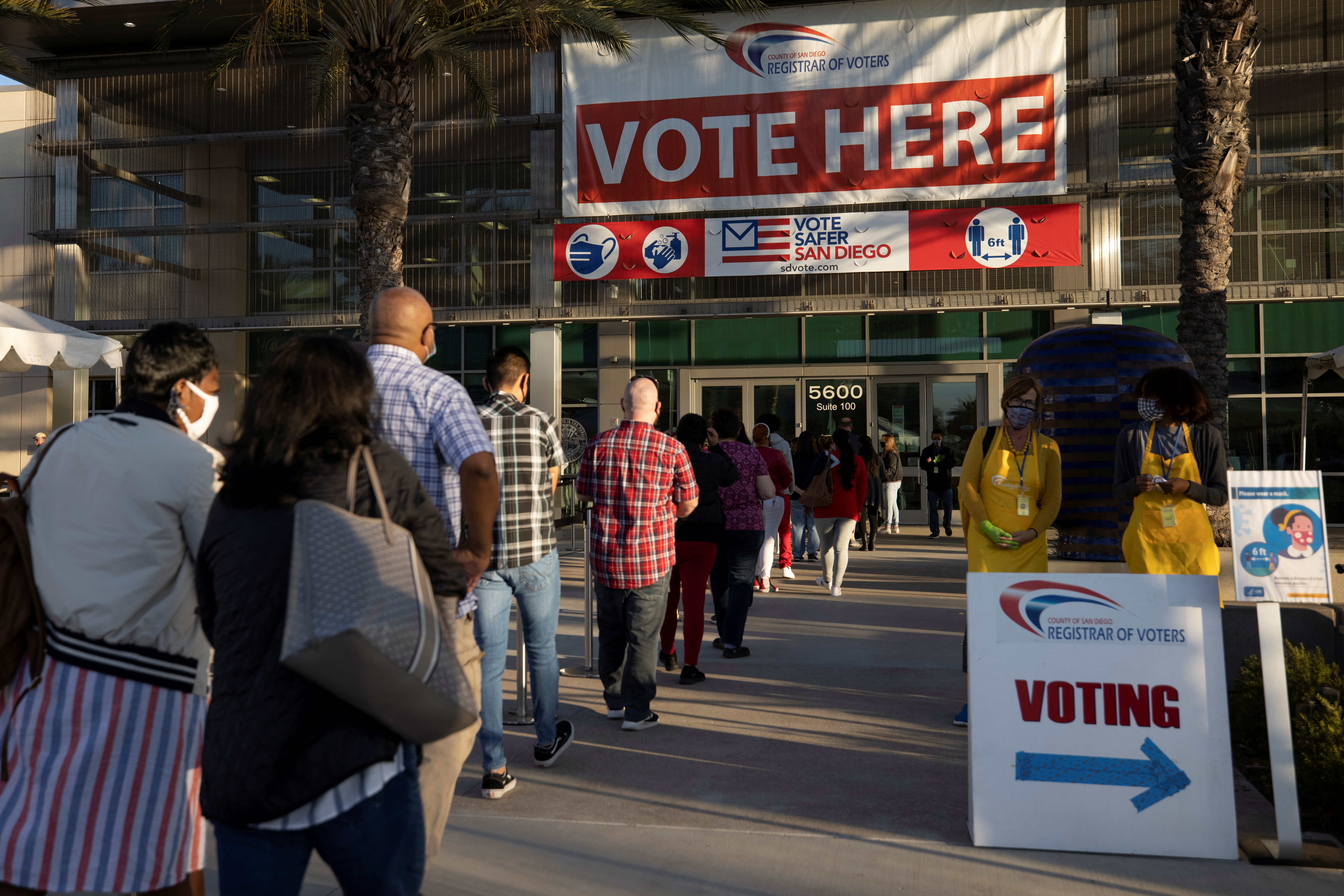 Poll workers wait in line to grab breakfast prior to the polls opening at the Registrar of Voters on the day of the U.S. Presidential election in San Diego, California