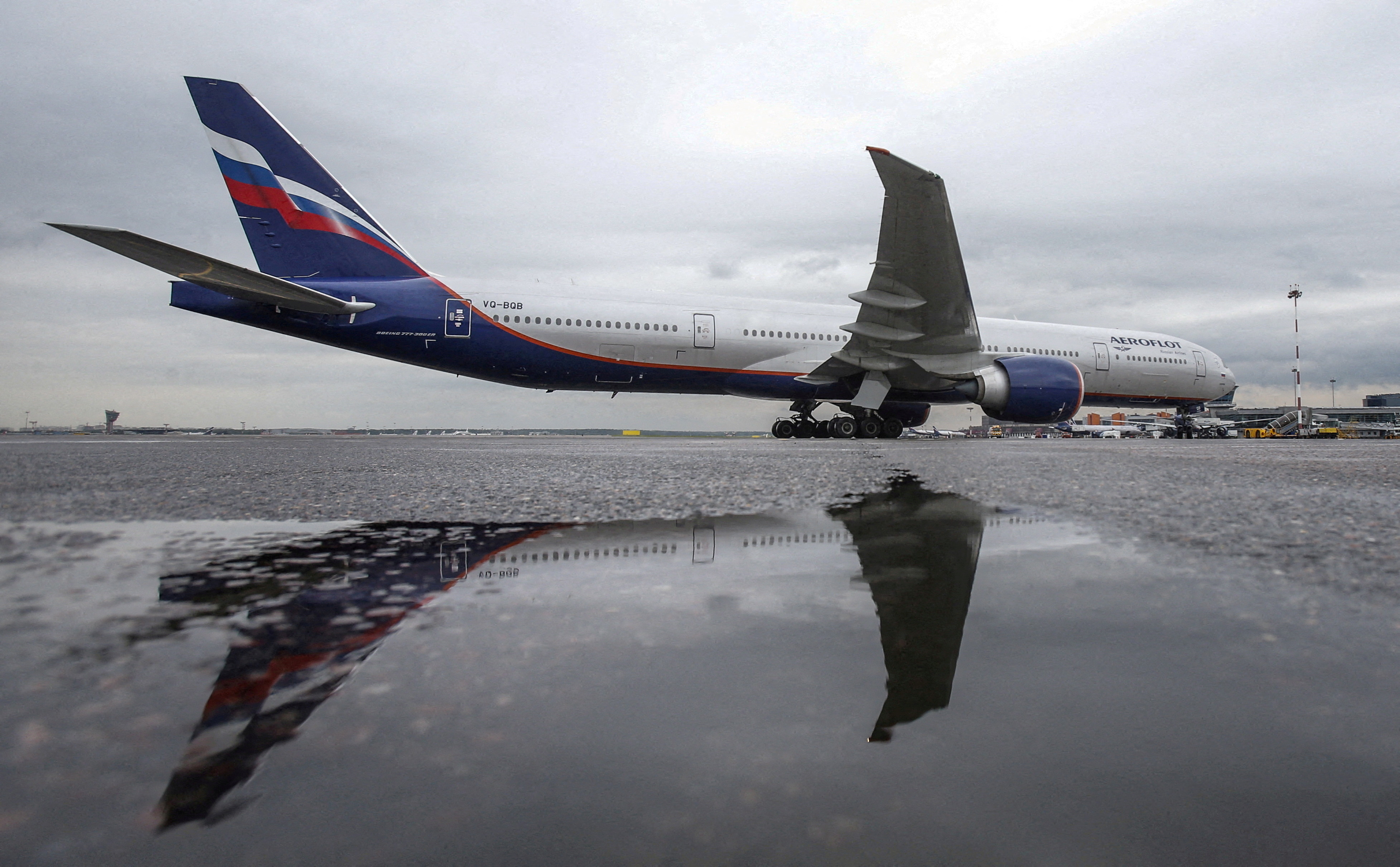 An Aeroflot Boeing 777-300ER aircraft is reflected in a puddle at Sheremetyevo International Airport outside Moscow