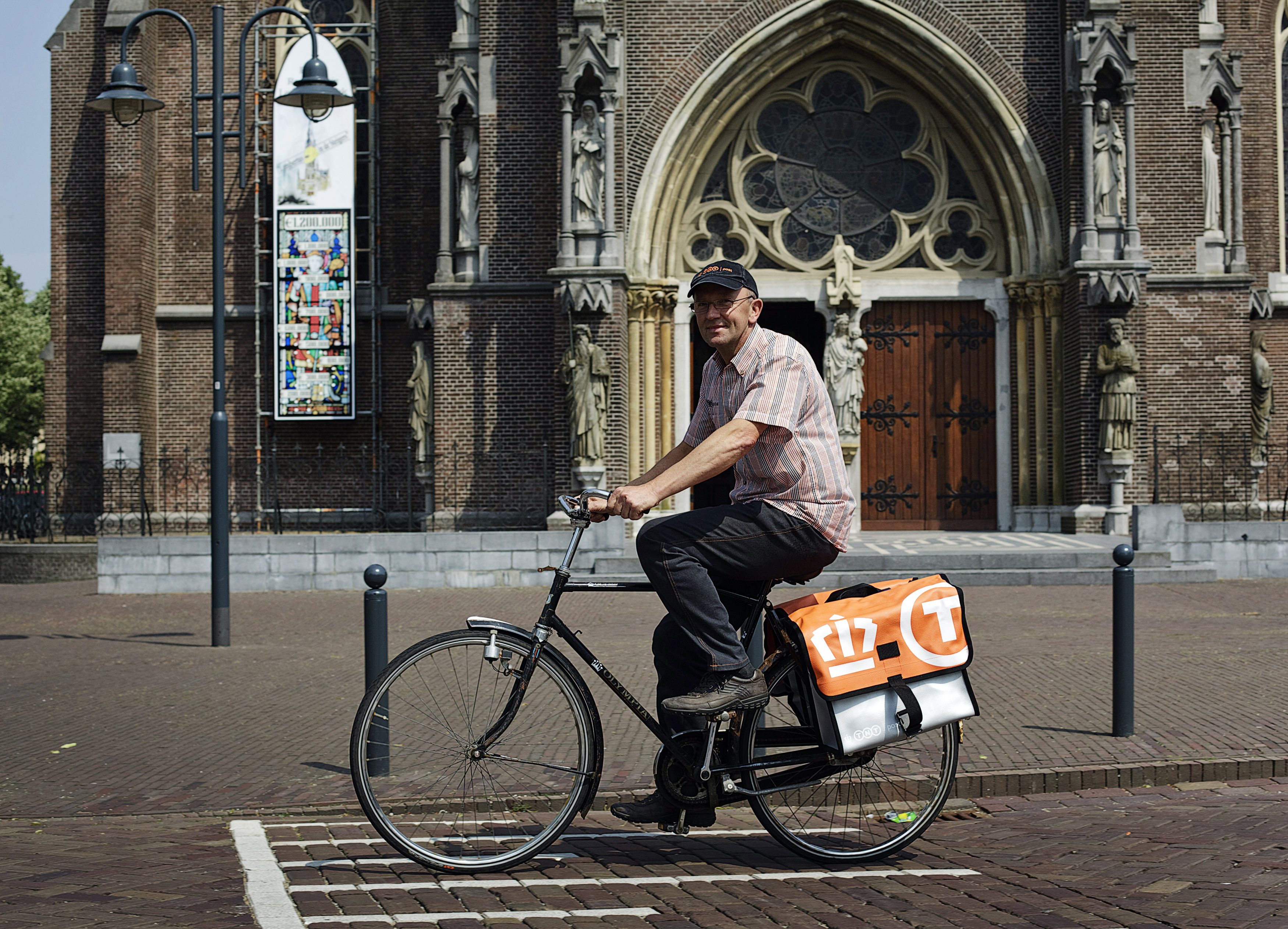 Postnl employee Jaap Bouwmans rides his bicycle to work in his hometown Veghel