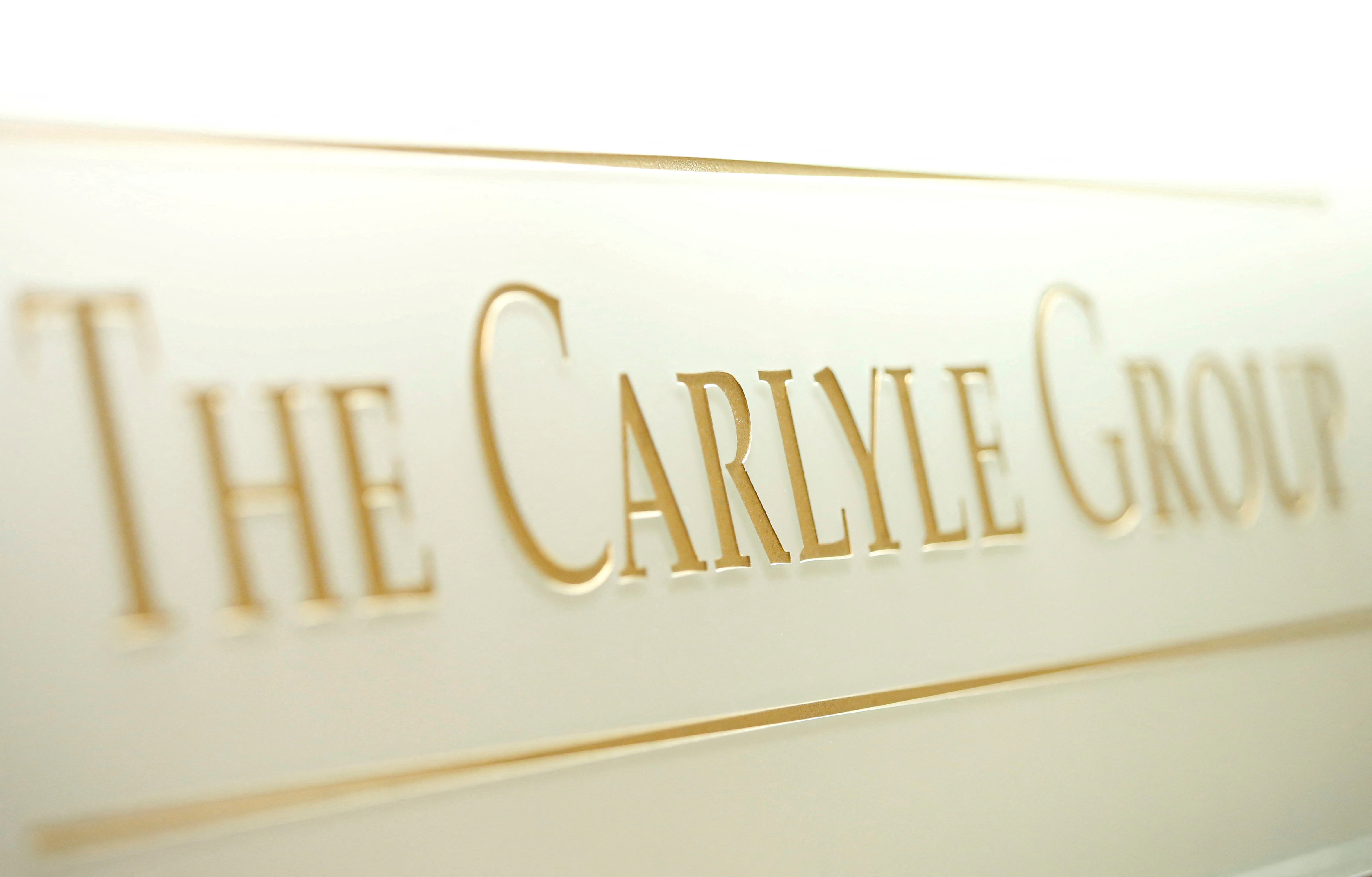 The logo of The Carlyle Group is displayed at the company's office in Tokyo