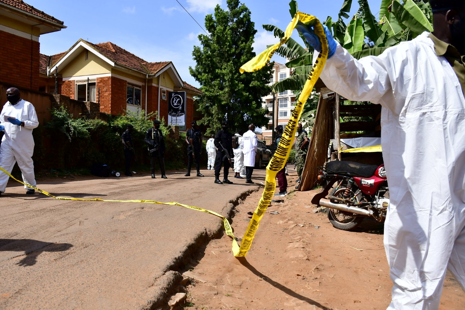 Security forces and forensic experts secure the scene of an attempted assassination on Ugandan minister of works and transport General Katumba Wamala in the suburb of Kiasasi within Kampala, Uganda June 1, 2021. REUTERS/Abubaker Lubowa
