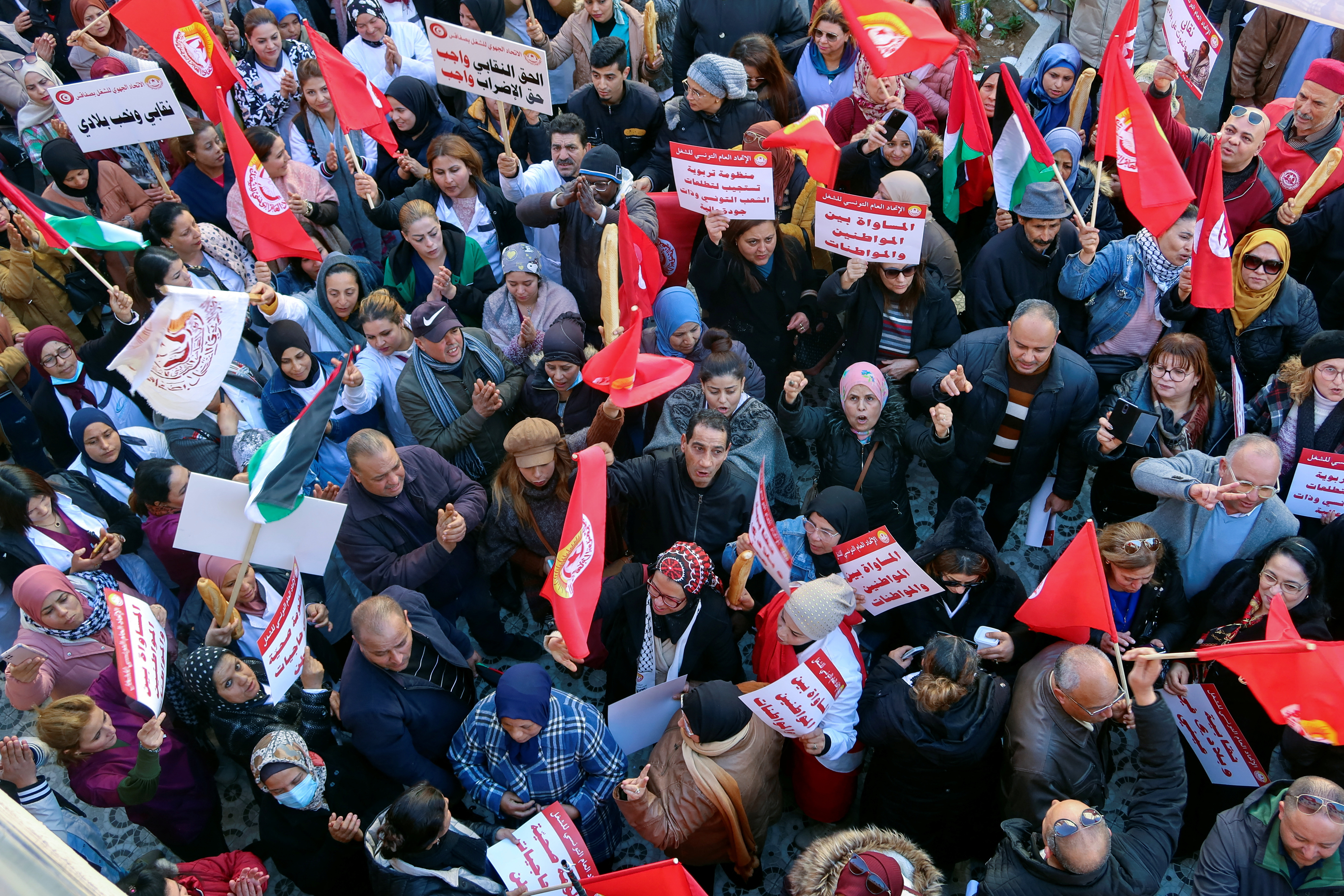 Supporters of the Tunisian General Labour Union (UGTT), carry flags and banners during a protest against what they say authority's attacks on freedoms and union rights, in Sfax