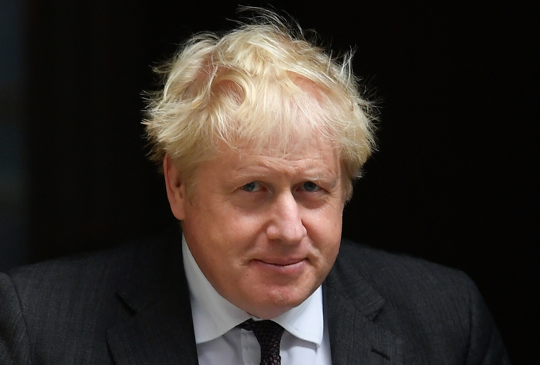 Britain's PM Johnson walks outside Downing Street in London