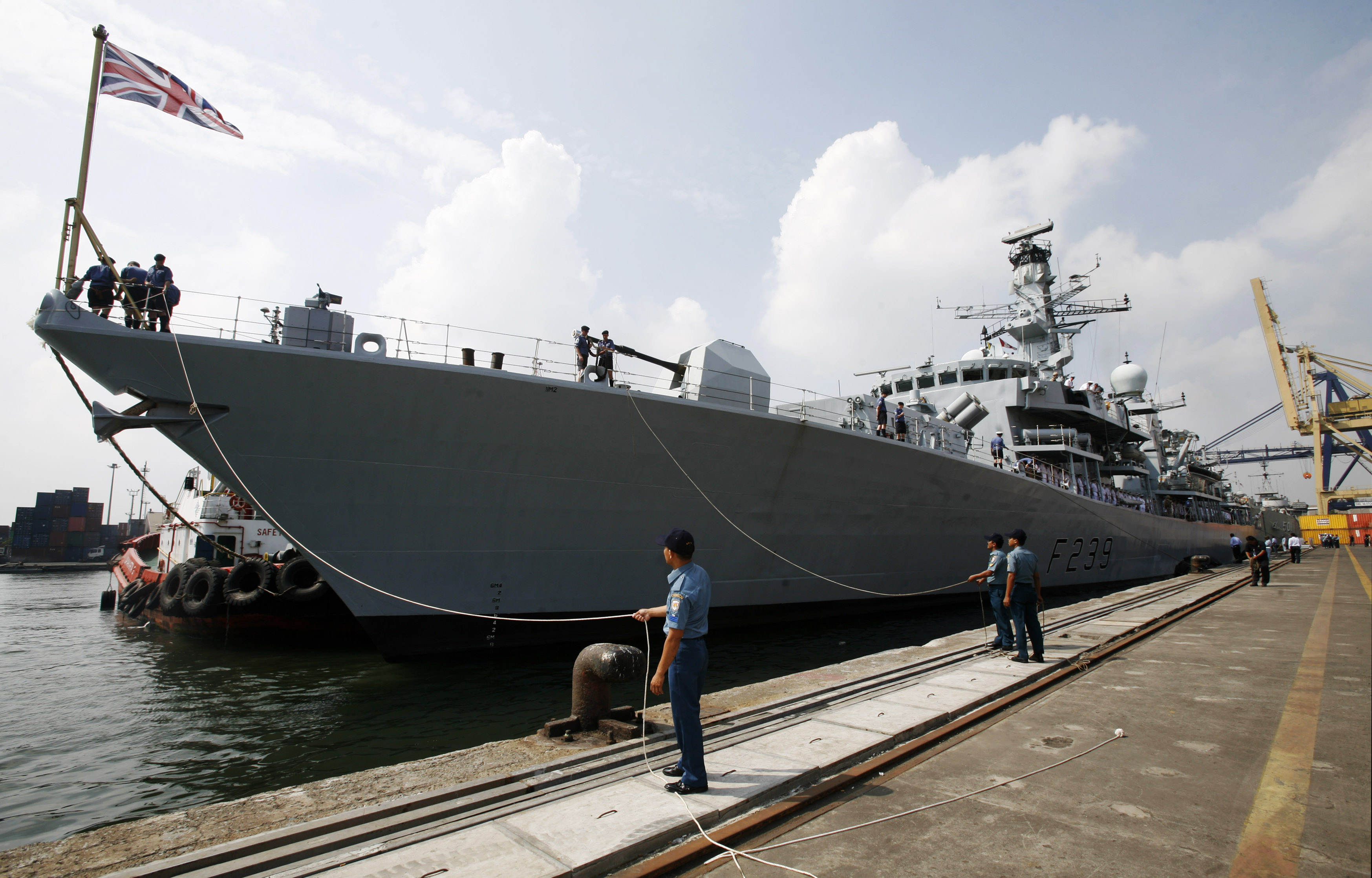 Officers of the Indonesian Navy greet the crew of the visiting British Royal Navy ship HMS Richmond docked in Jakarta