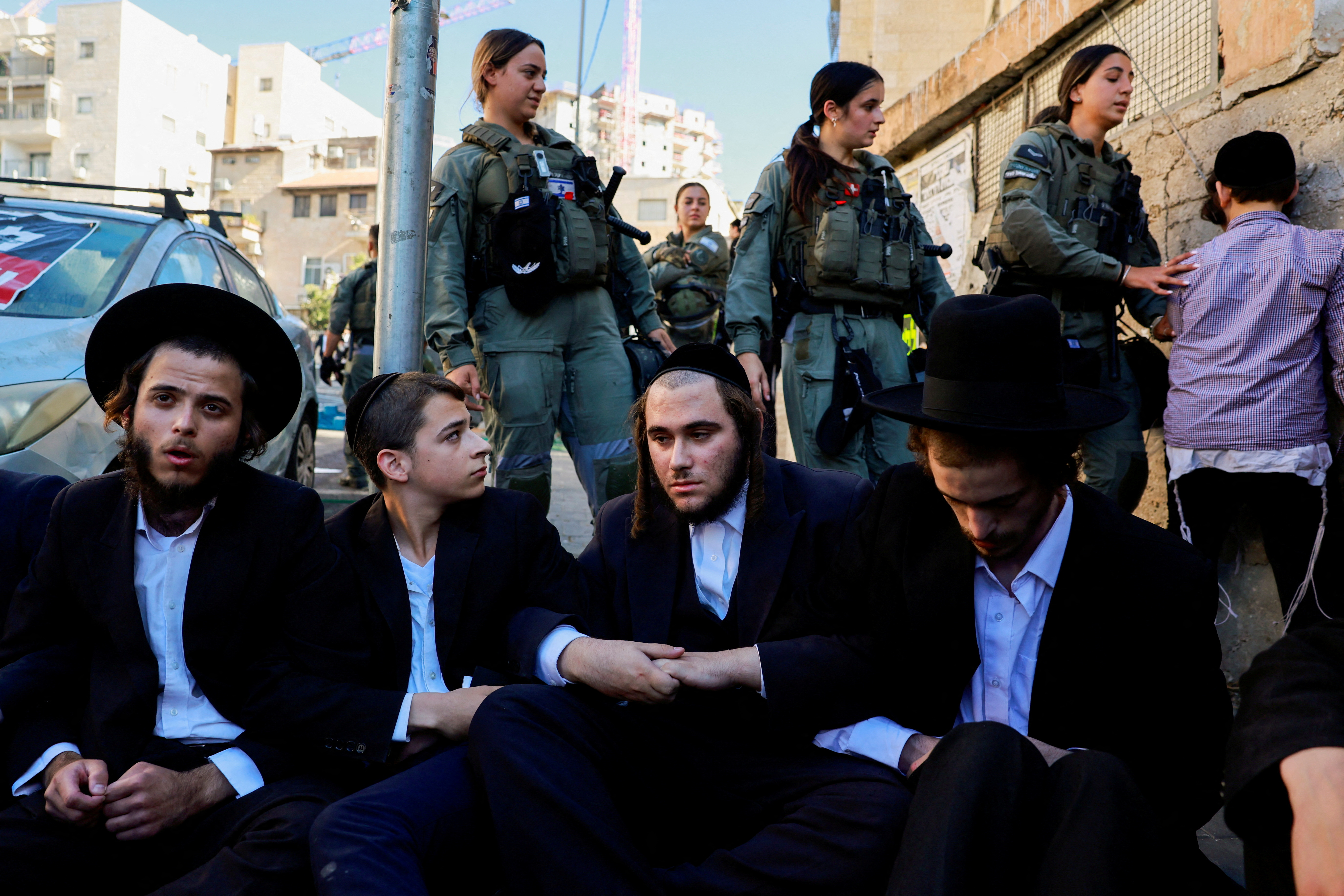 Ultra-Orthodox Jewish men protest against attempts to recruit men from the community, in Jerusalem