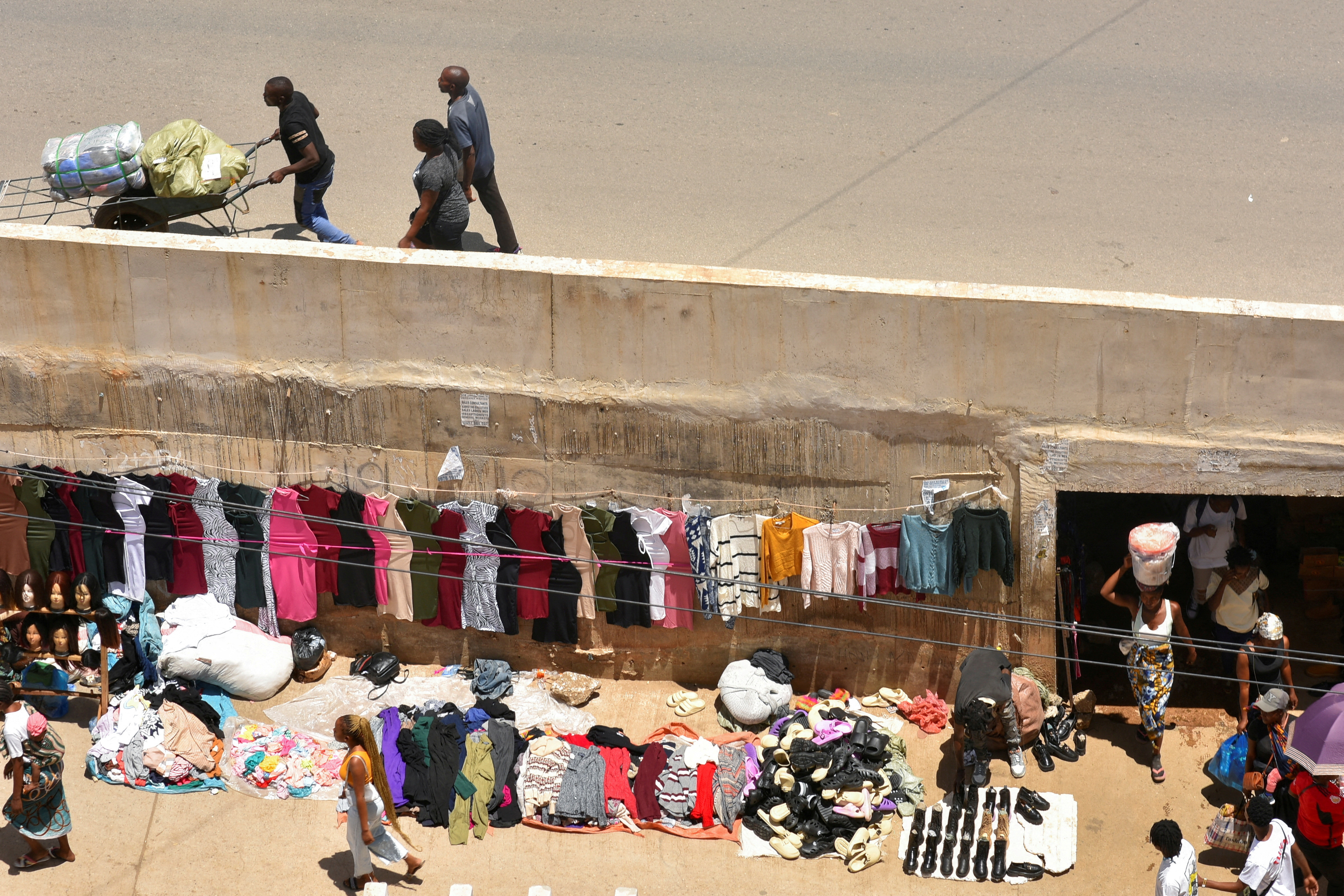 Vendors sell goods at a market in Lusaka