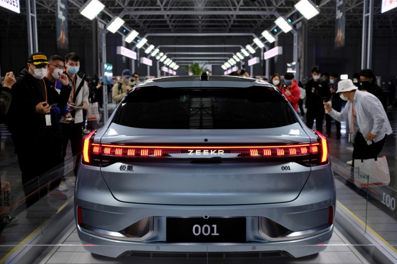 Visitors check a Zeekr 001, a model from Geely's new brand Zeekr, at its factory in Ningbo