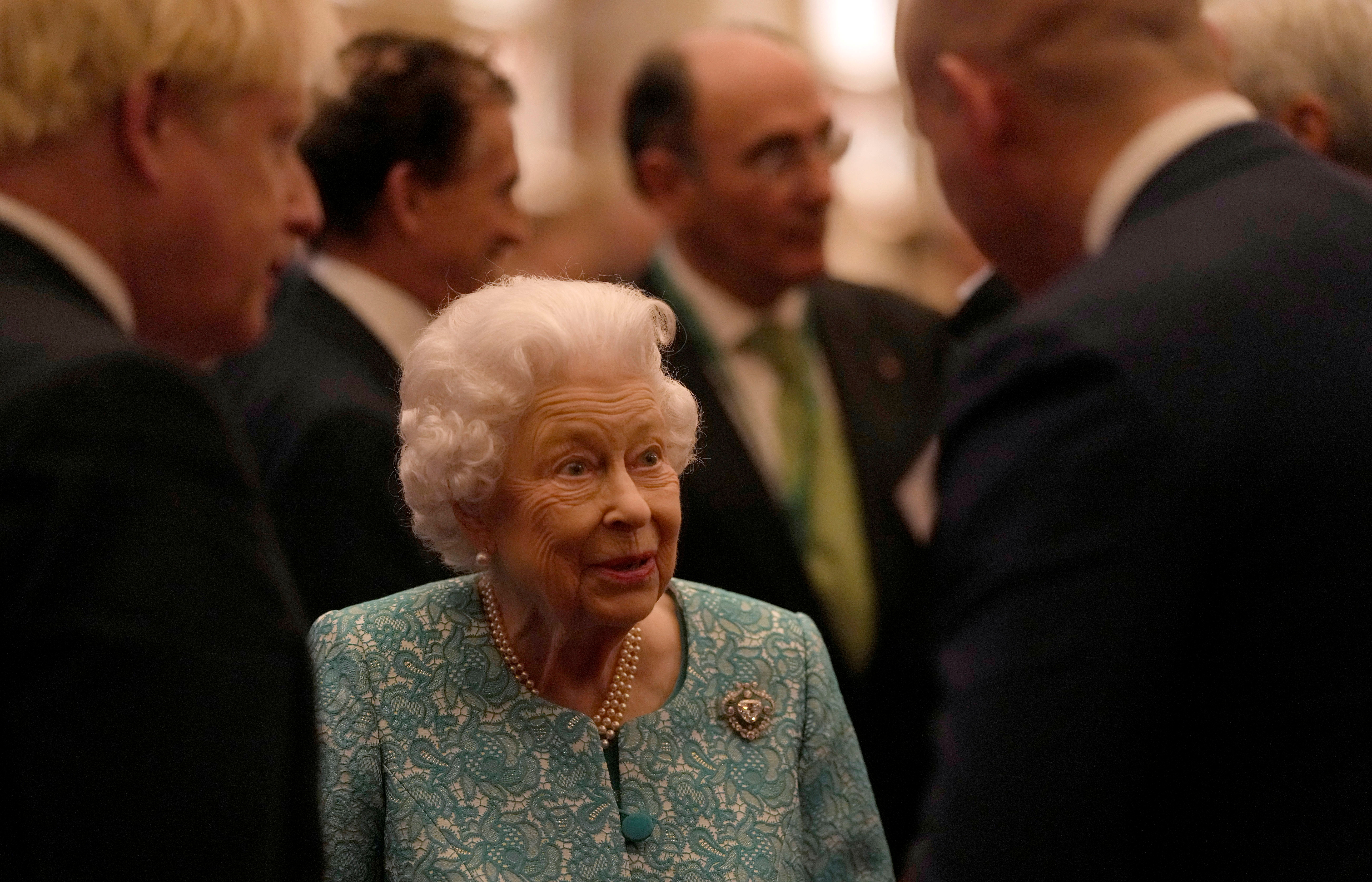 Britain's Queen Elizabeth and Prime Minister Boris Johnson greet guests at a reception for the Global Investment Summit in Windsor Castle, Windsor, Britain, October 19, 2021. Alastair Grant/Pool via REUTERS