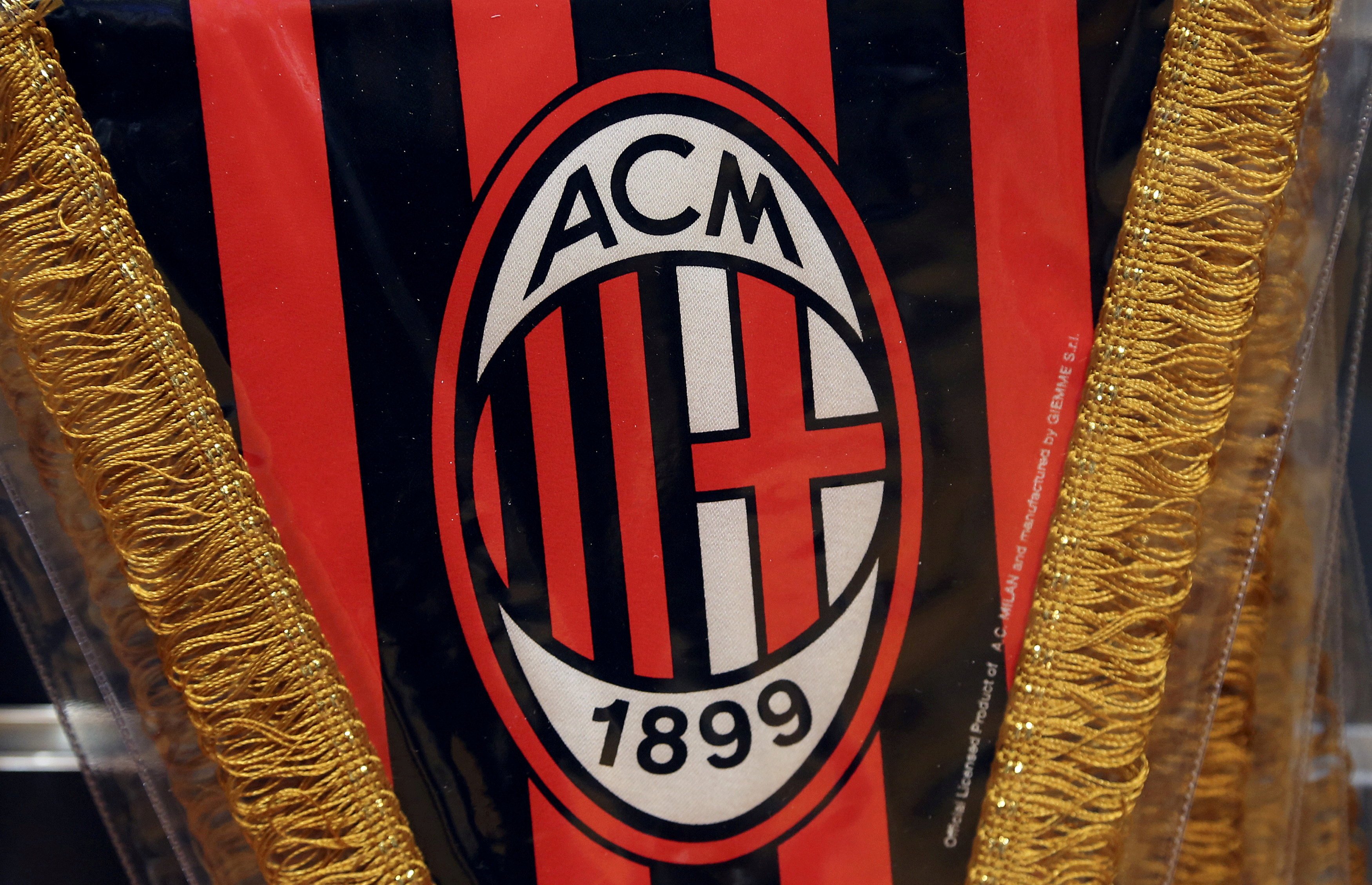 The AC Milan logo is pictured on a pennant in a soccer store in downtown Milan
