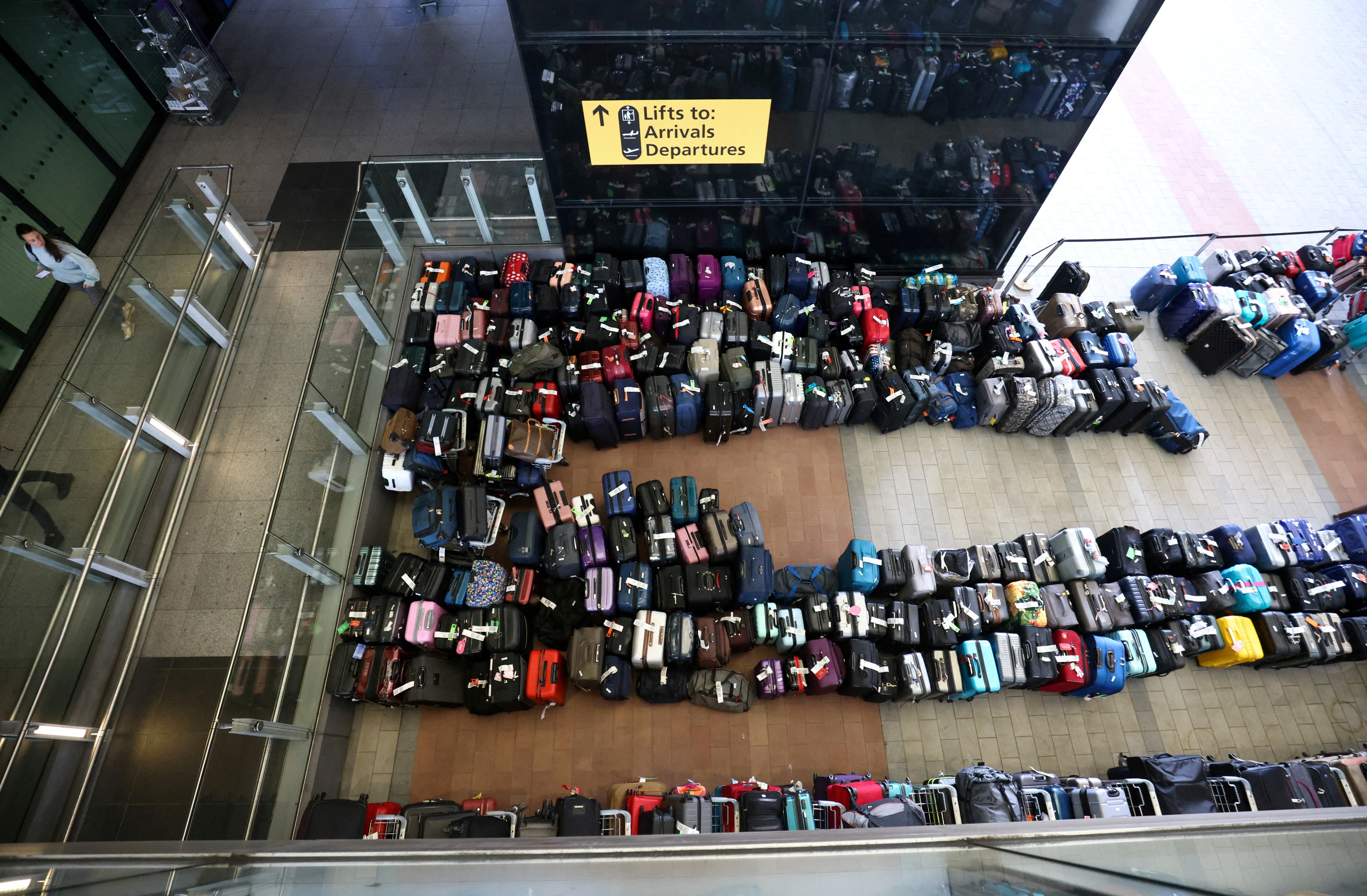 Lines of passenger luggage lie arranged outside Terminal 2 at Heathrow Airport in London