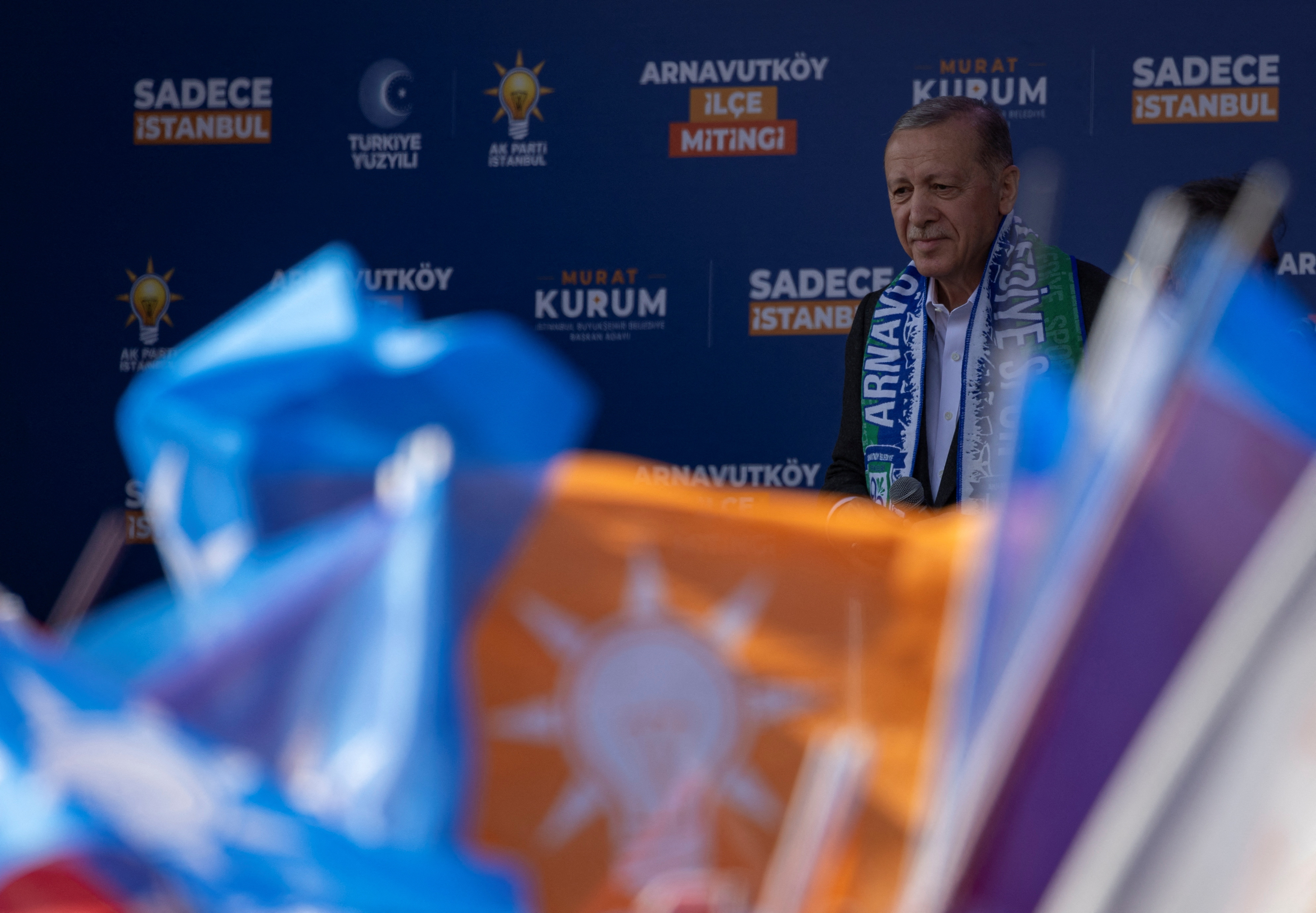 Turkish President Tayyip Erdogan reacts as he addresses his supporters during a rally ahead of the local elections in Istanbul