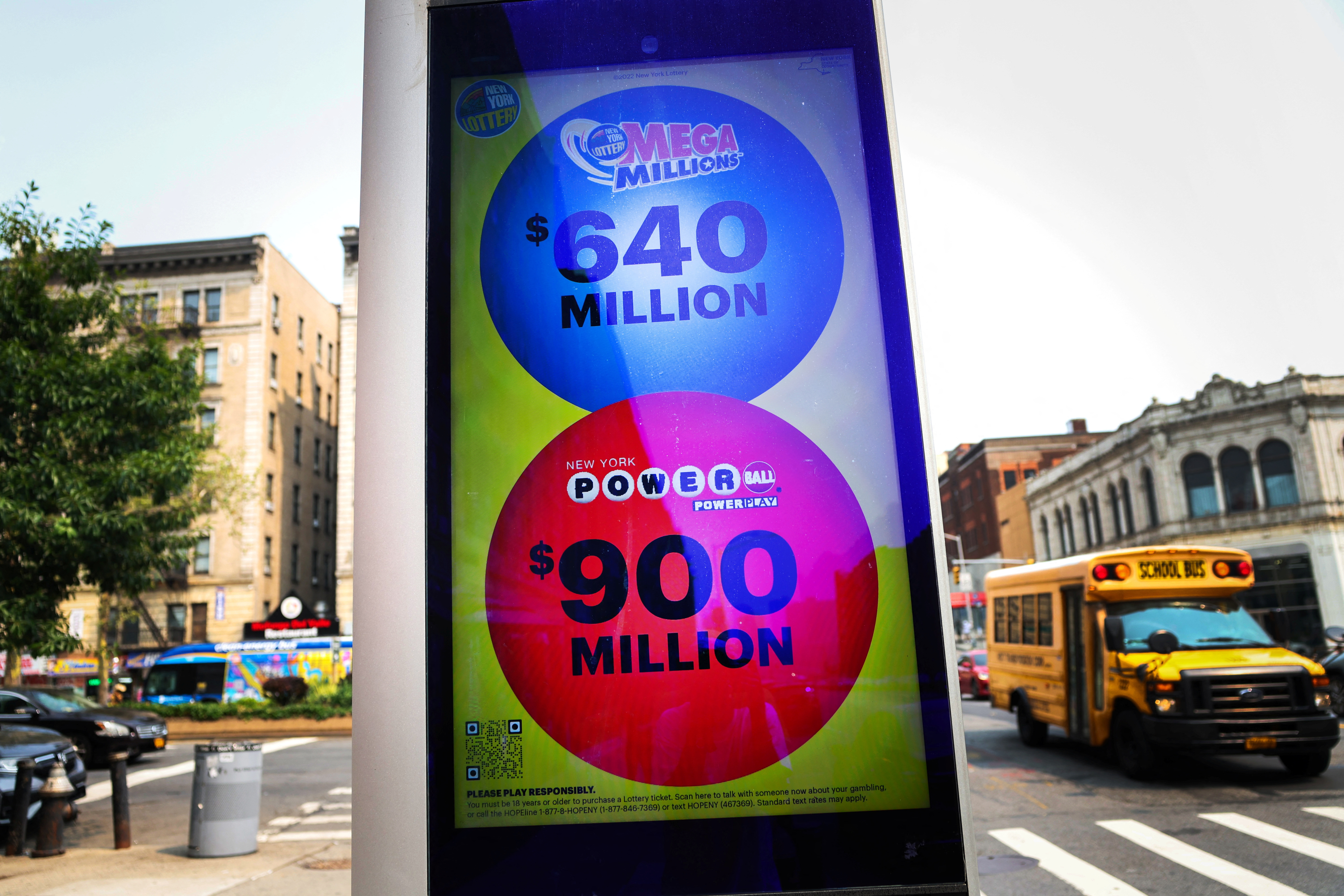 An electronic message board displays Powerball and Mega Millions lottery jackpots in New York