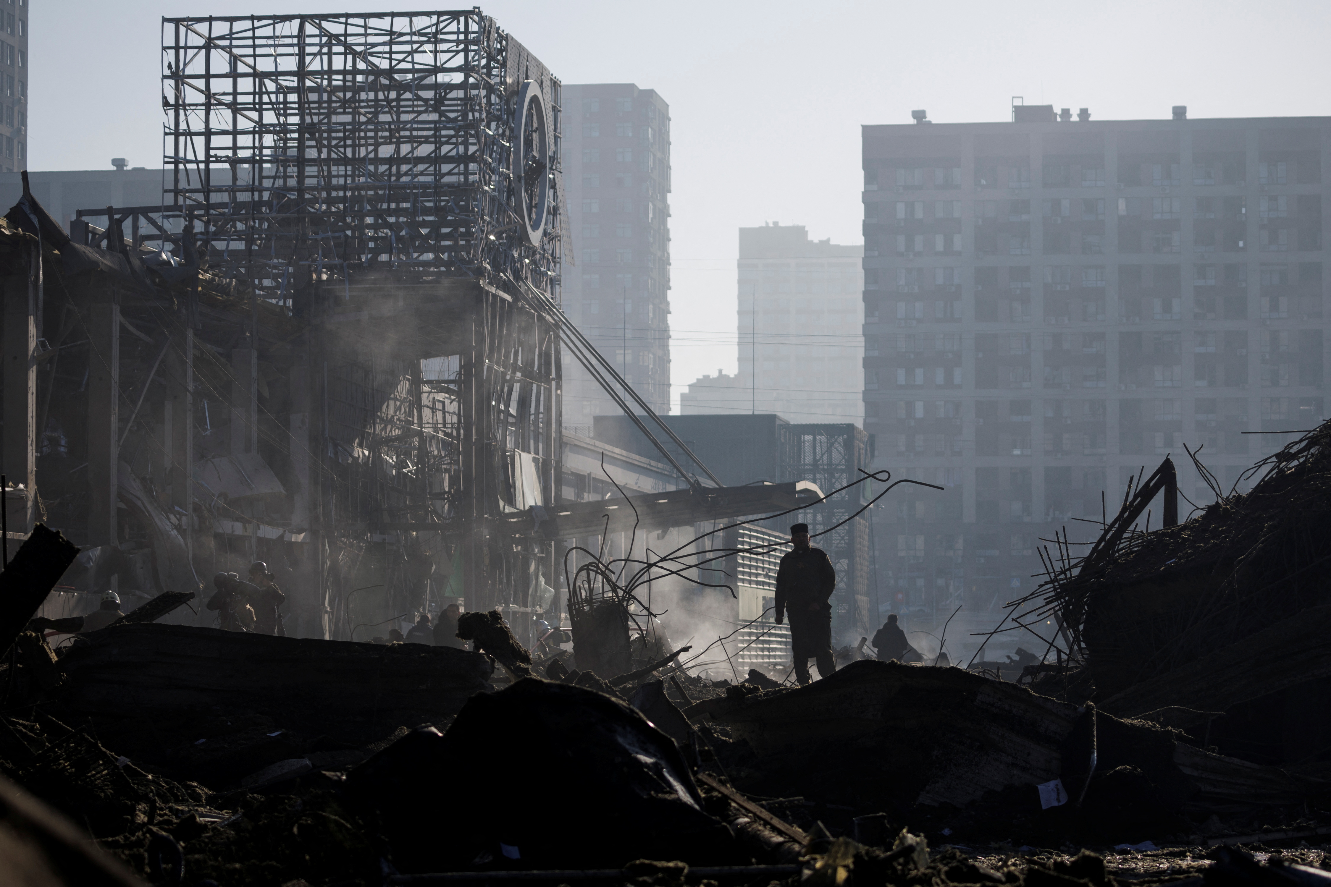Priest stands at the site of a bombing at a shopping center in Kyiv