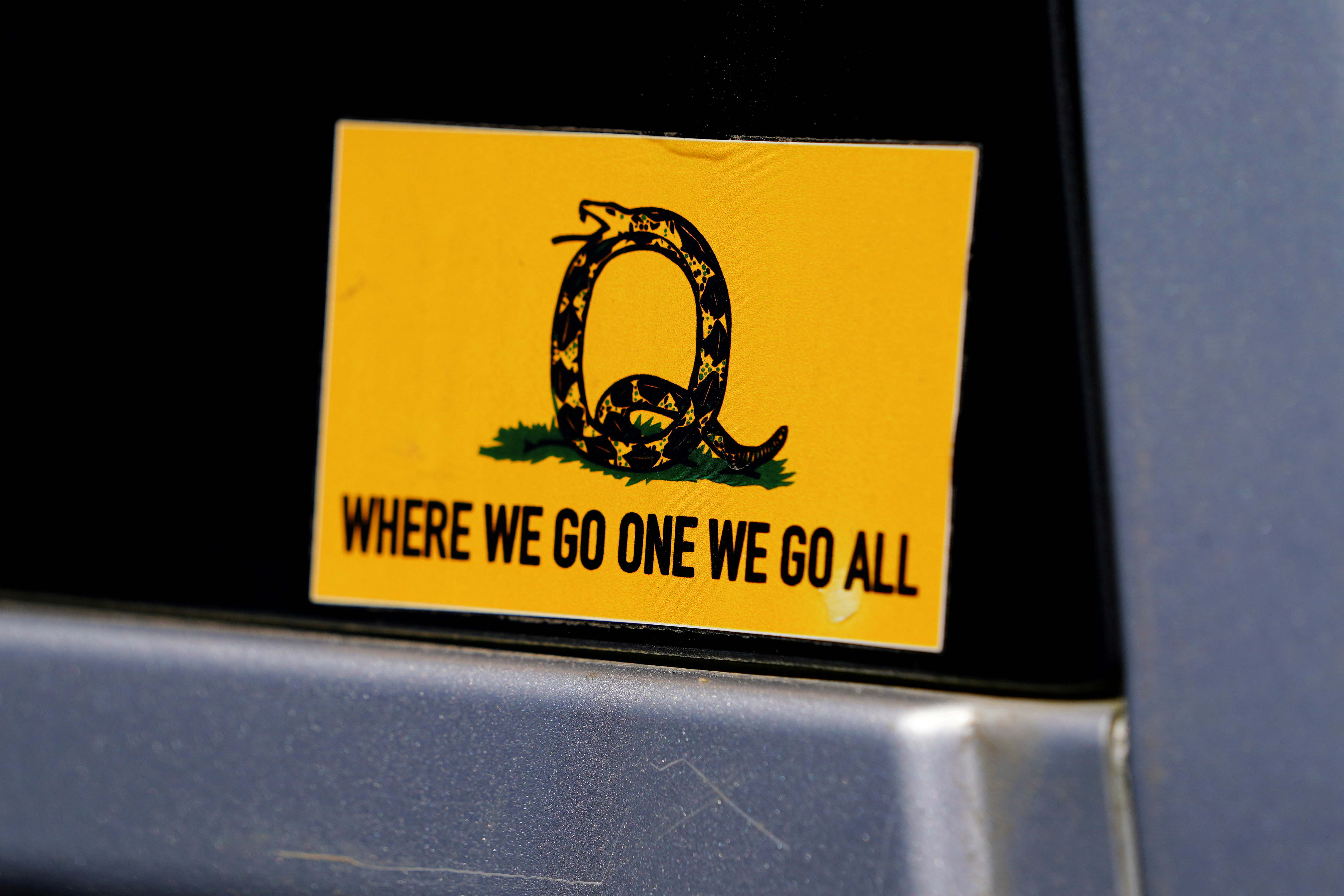 A sticker that references the QAnon slogan is seen on a truck that participated in a caravan convoy in Adairsville