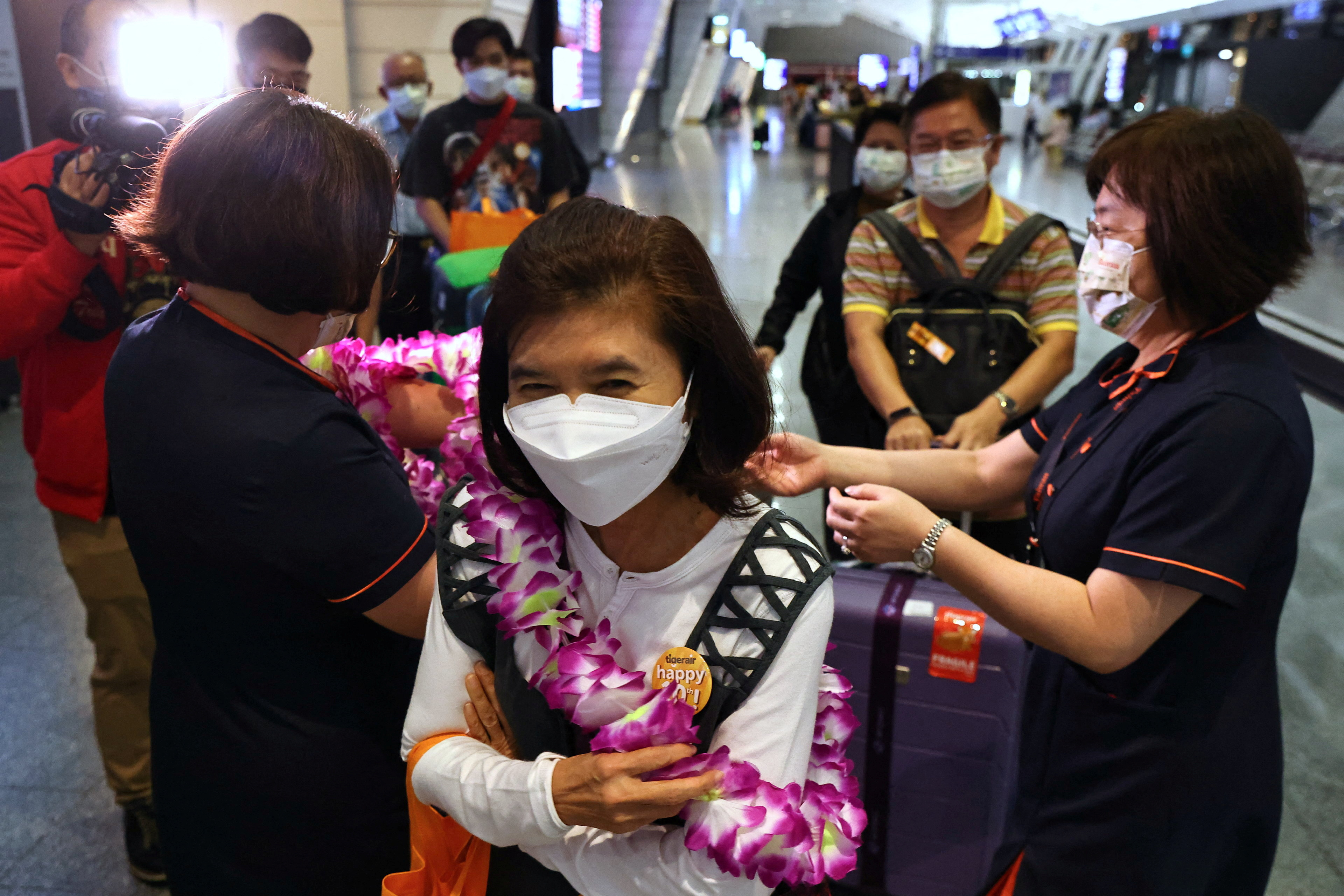 Travellers from Thailand on the first quarantine free flight to Taiwan receive welcome by officials and the media at the airport in Taoyuan,