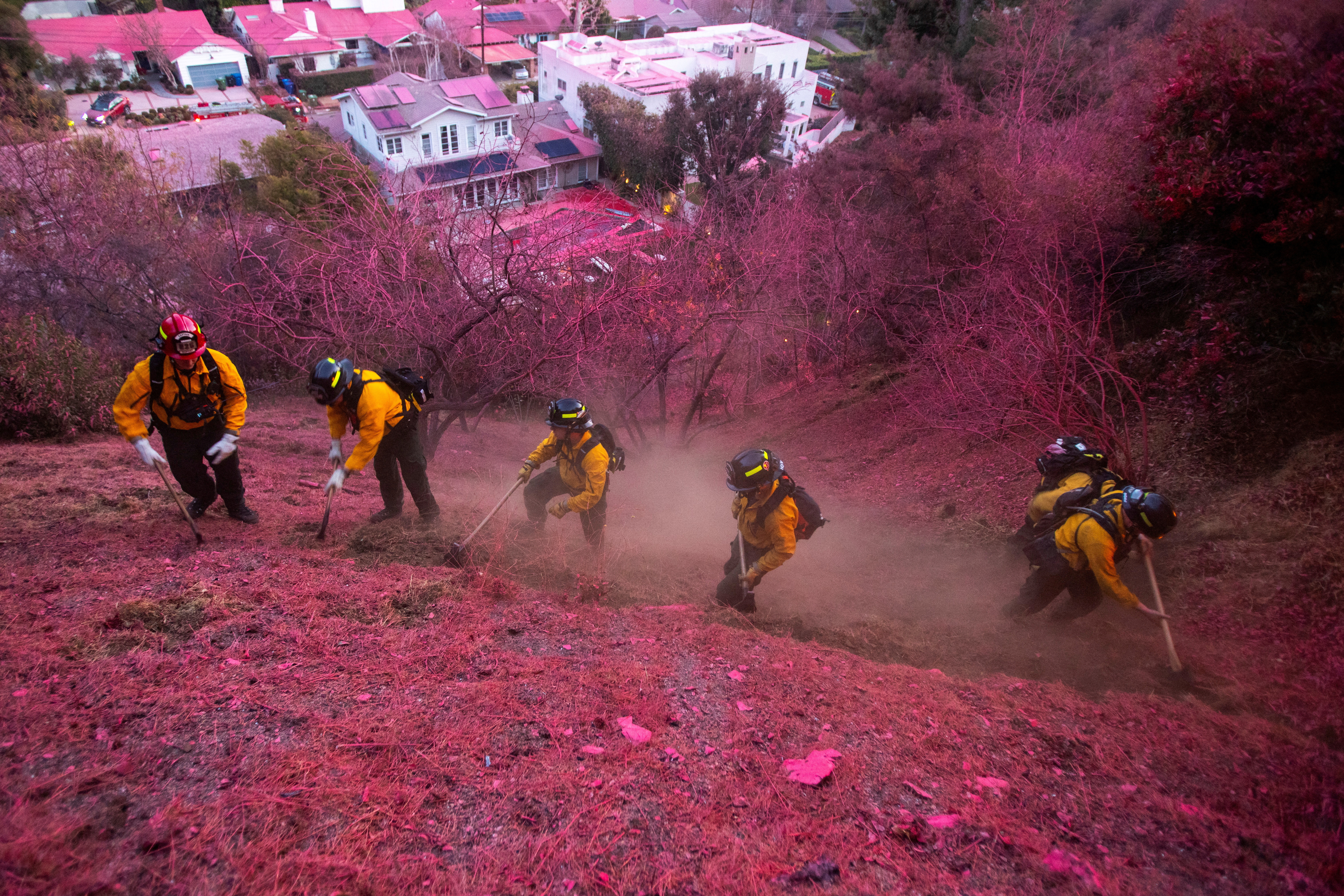 Pink fire retardant covers Los Angeles as crews race to contain