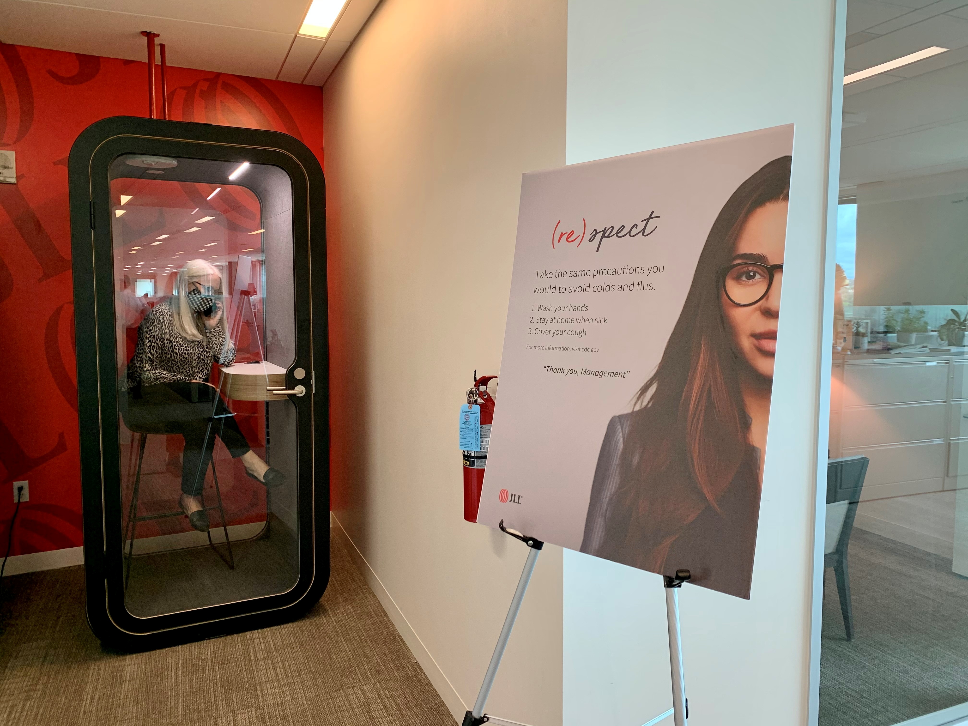 An employee makes a call in a newly-installed phone booth at real estate company JLL's Austin office