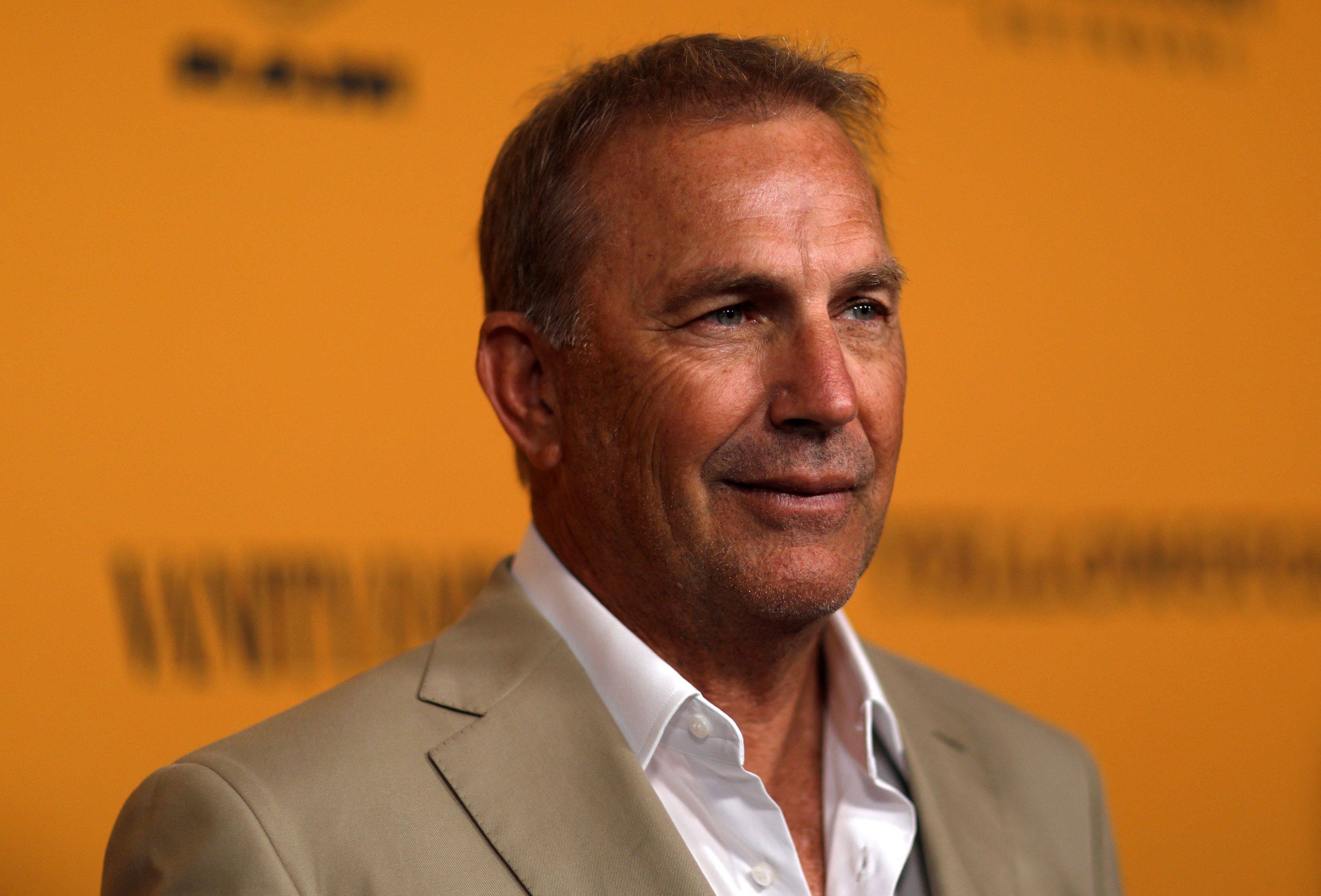 Cast member Costner poses at a premiere for the television series 