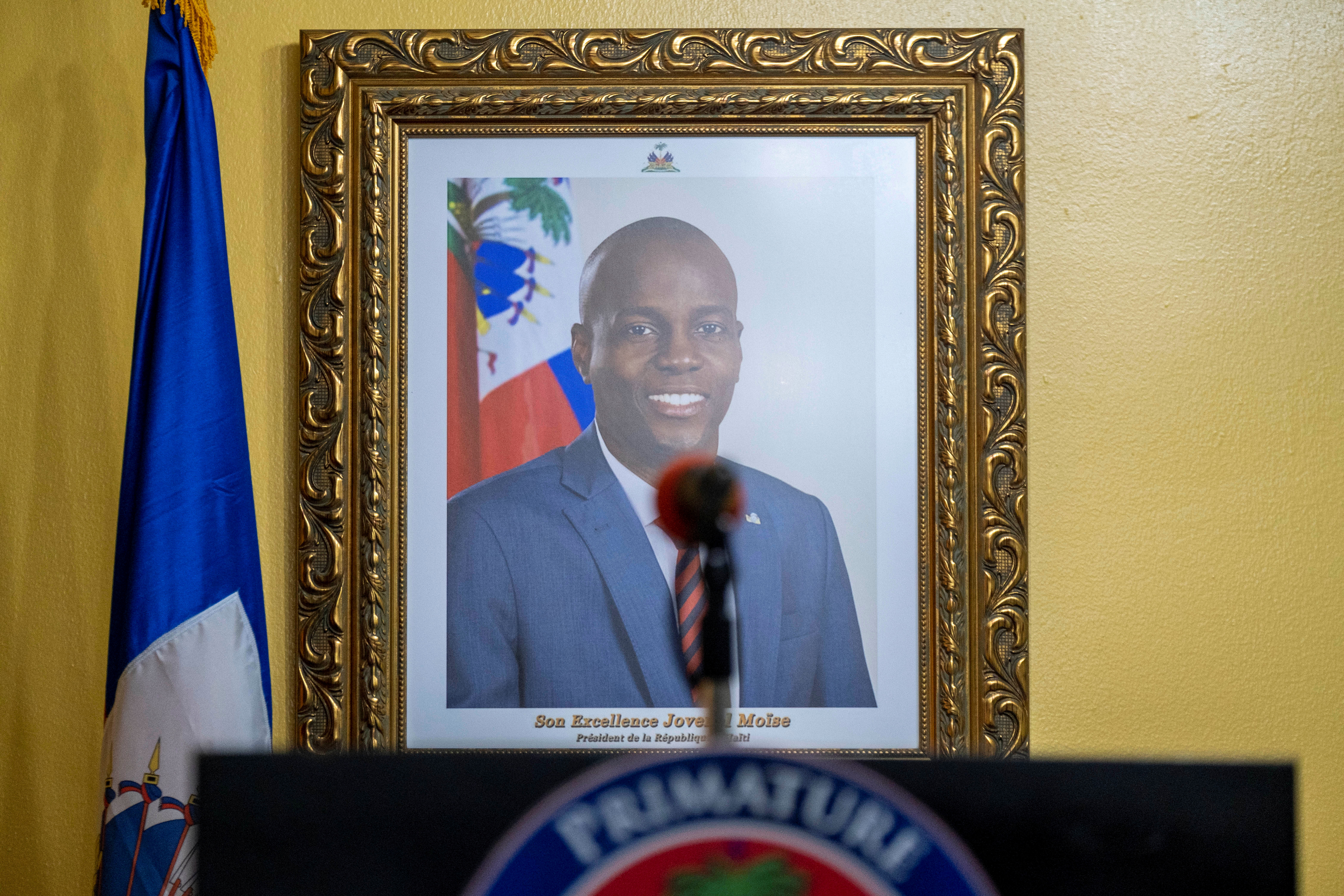 A picture of the late Haitian President Jovenel Moise hangs on a wall before a news conference by interim Prime Minister Claude Joseph at his house, almost a week after his assassination, in Port-au-Prince, Haiti July 13, 2021. REUTERS/Ricardo Arduengo