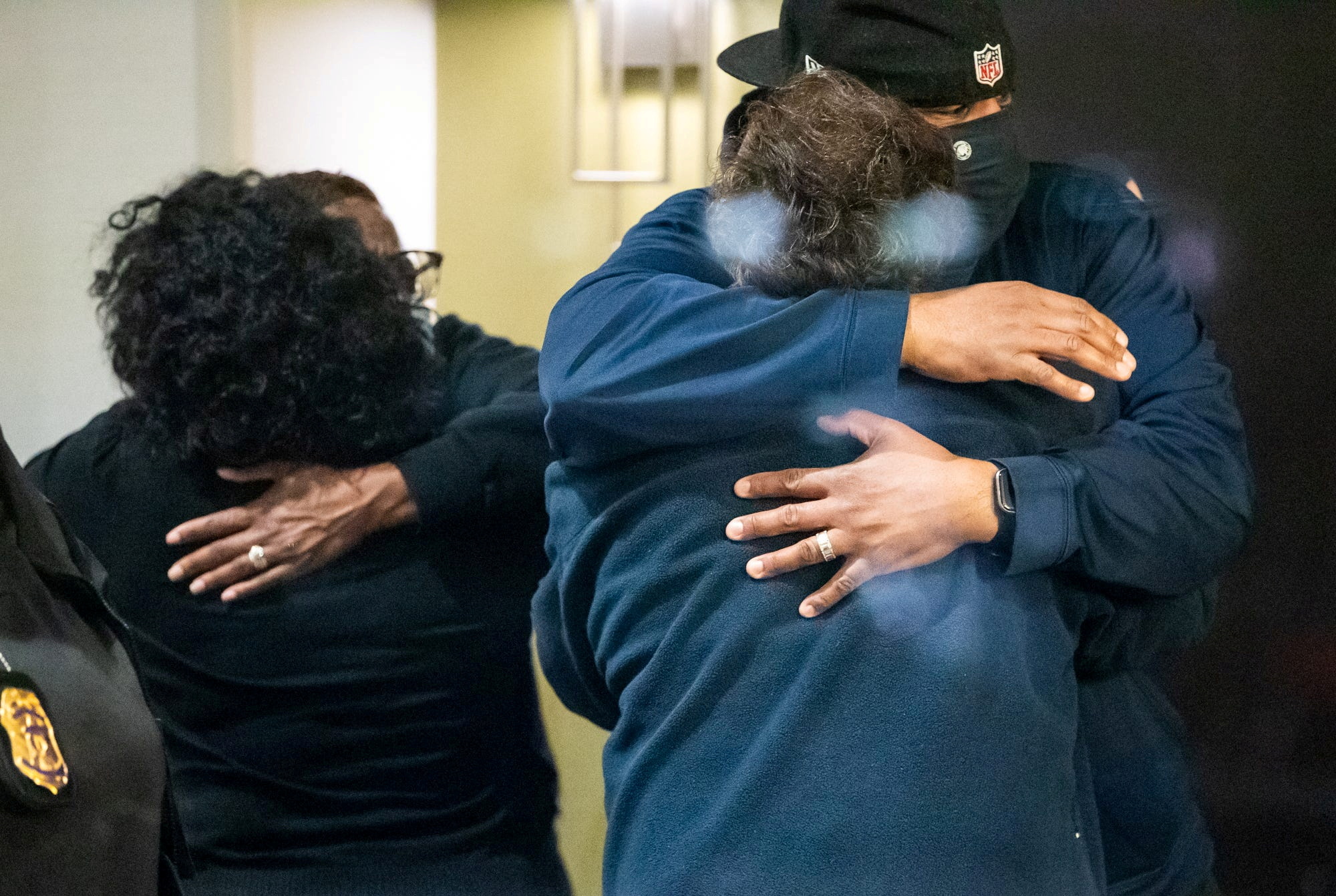 People embrace after learning that their loved one was safe after a mass casualty shooting at the FedEx facility in Indianapolis