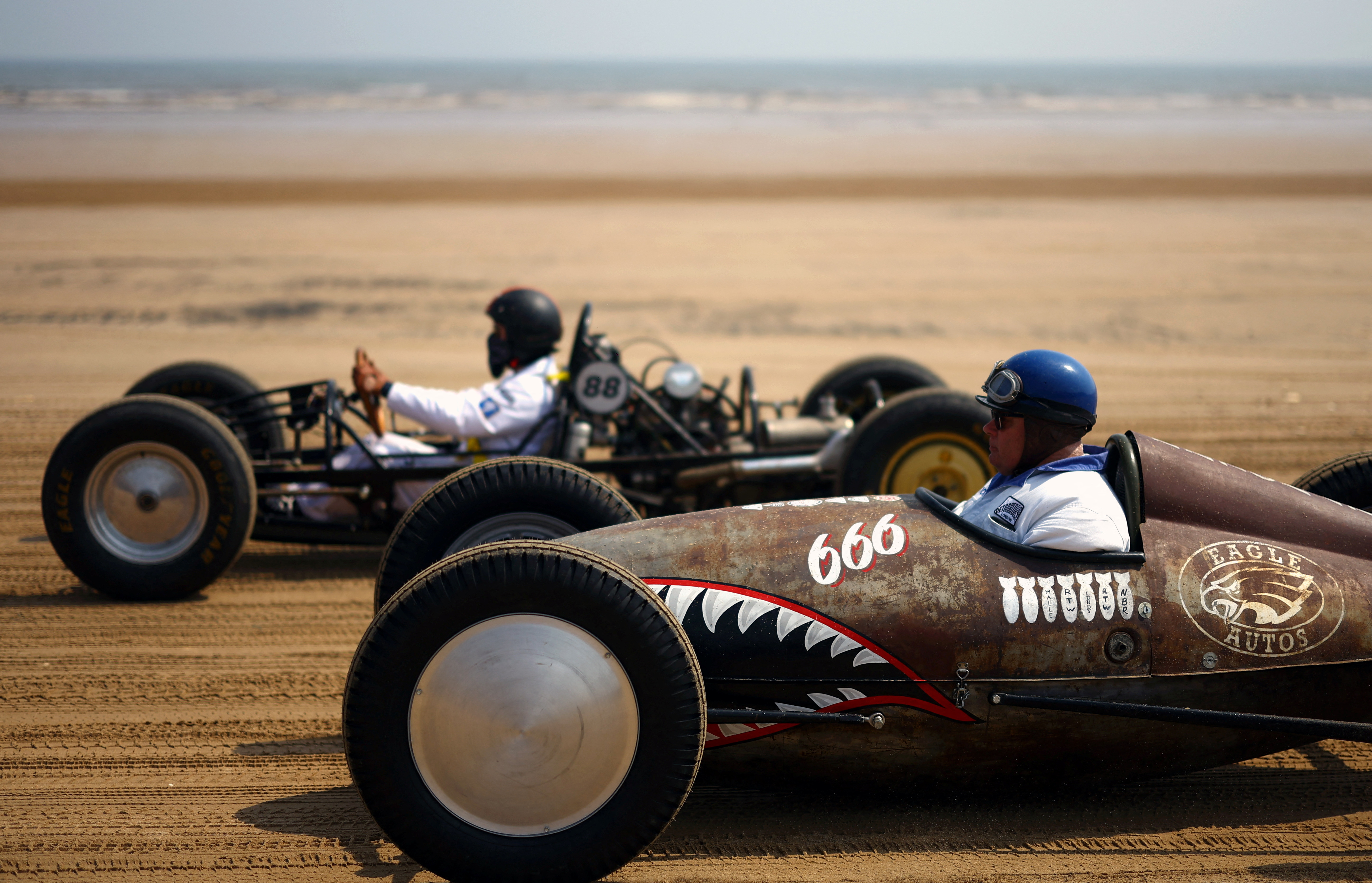 Motoring enthusiasts take part in the 'Race The Waves' classic car and motorcycle meet at the beach in Bridlington