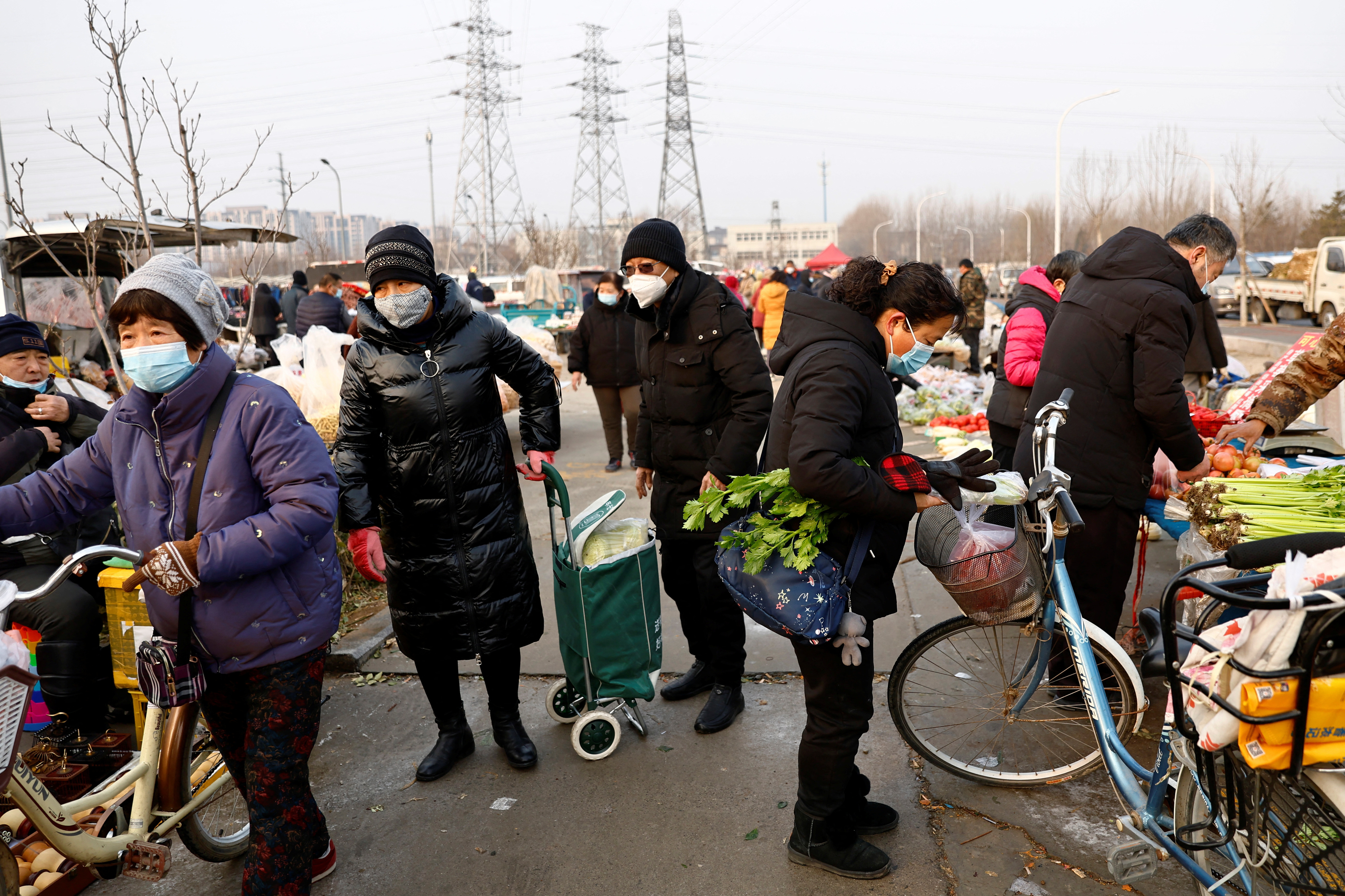 People shop at a market in Beijing