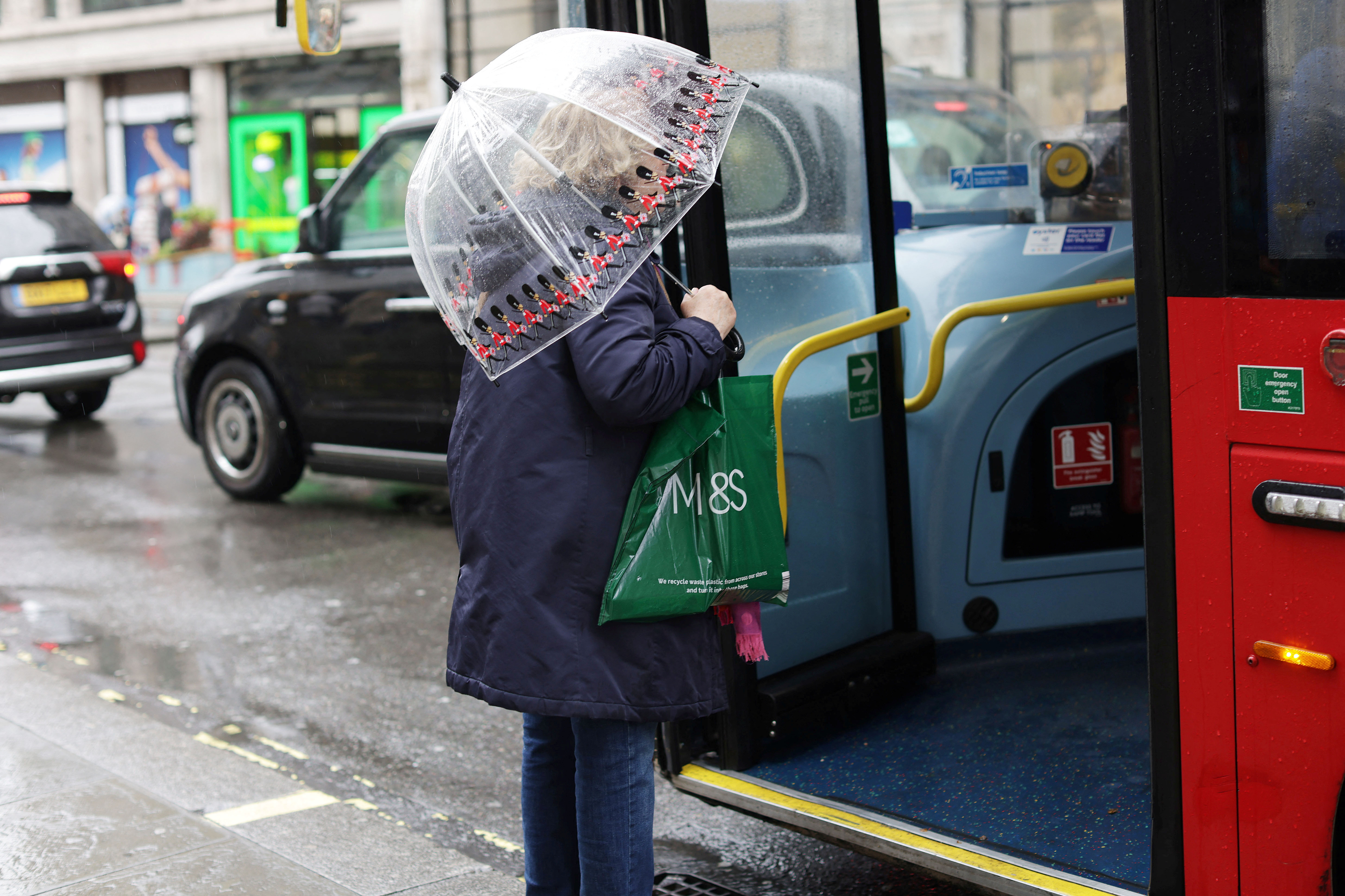 A person holds a shopping bag on Oxford Street in London